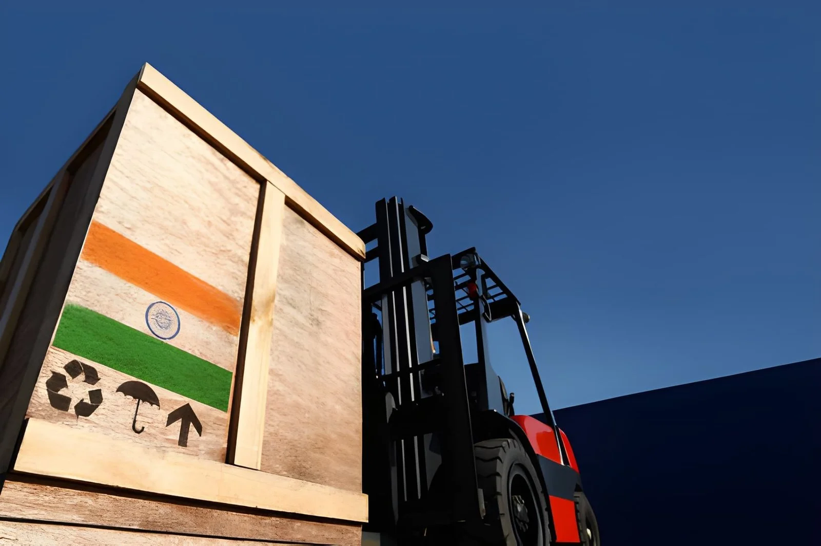 A forklift lifting a wooden crate painted with the Indian flag and recycling symbols under a clear blue sky.