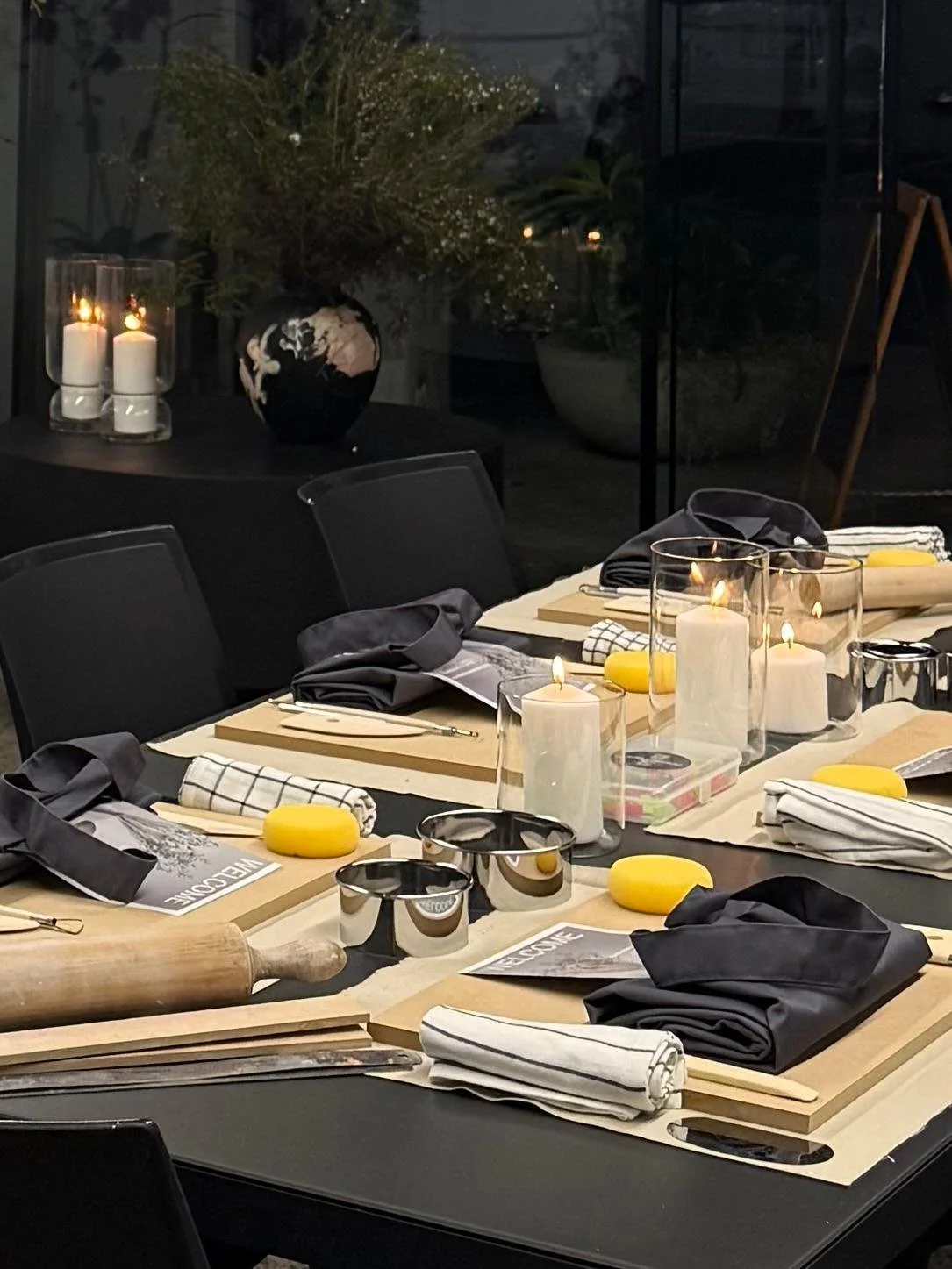 Beautiful ceramic workshop tables set in a modern studio space with candlelight, flowers and luxury pottery tools and ambience.