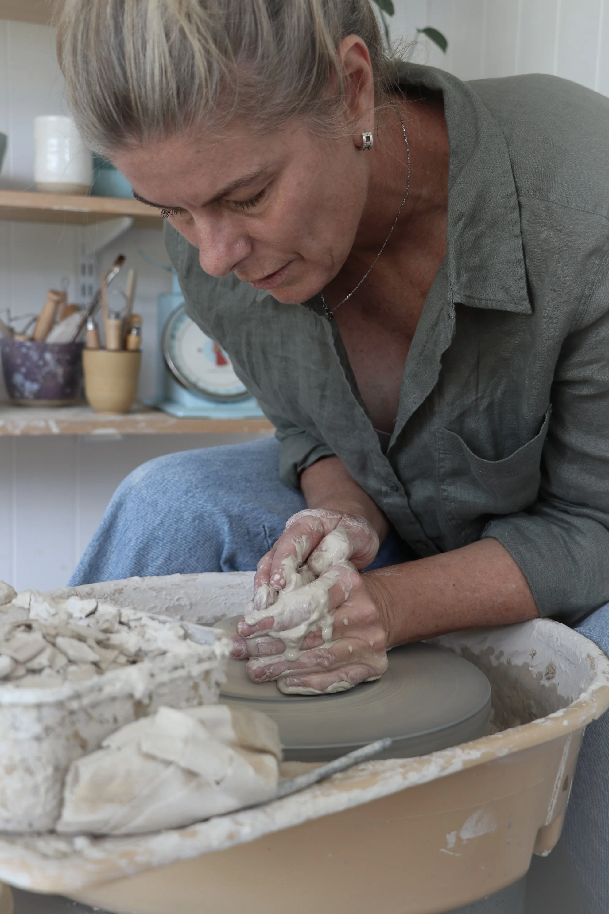 Founder of Pettit Ceramics throwing clay on the pottery wheel