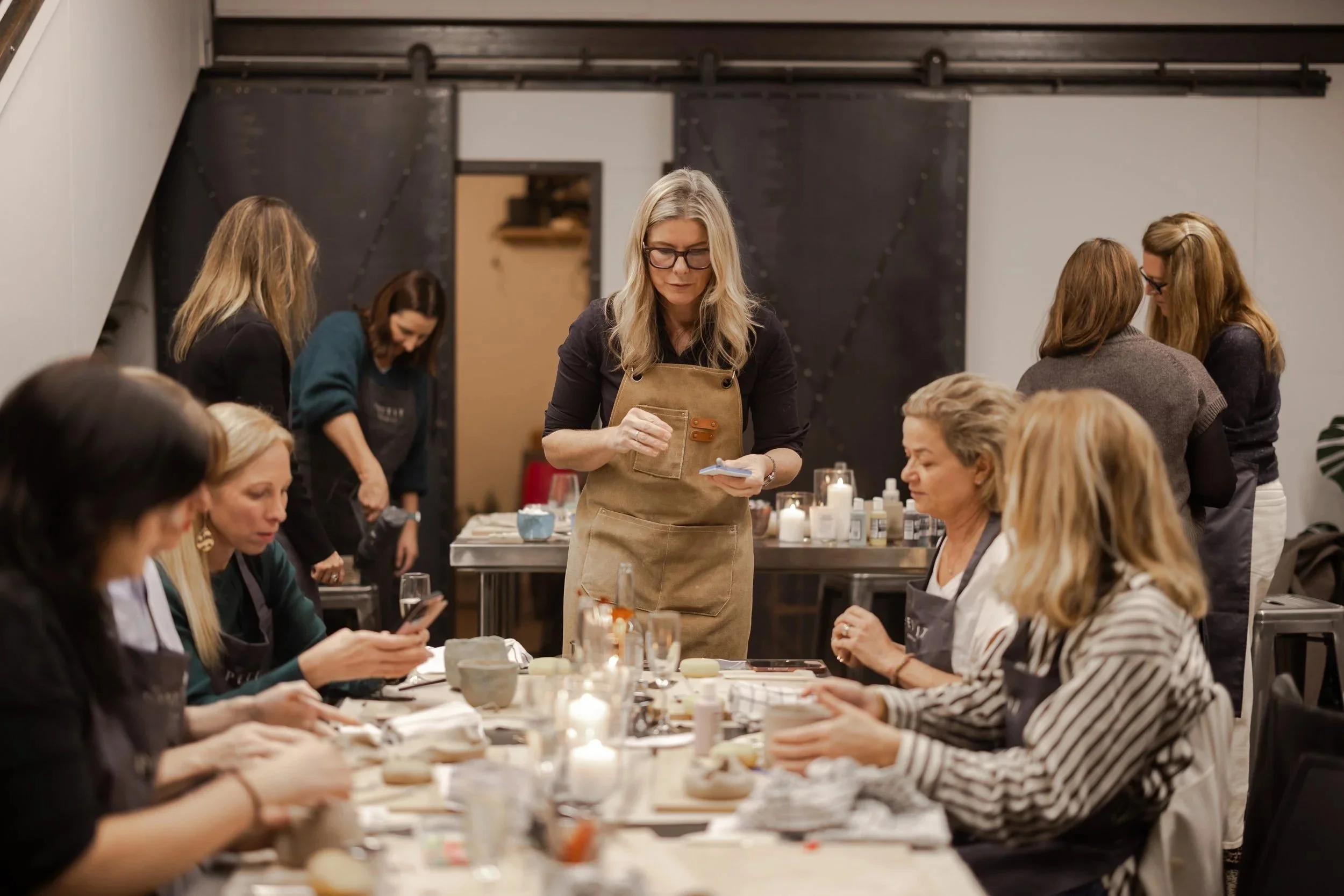 A group of people making ceramics at a birthday