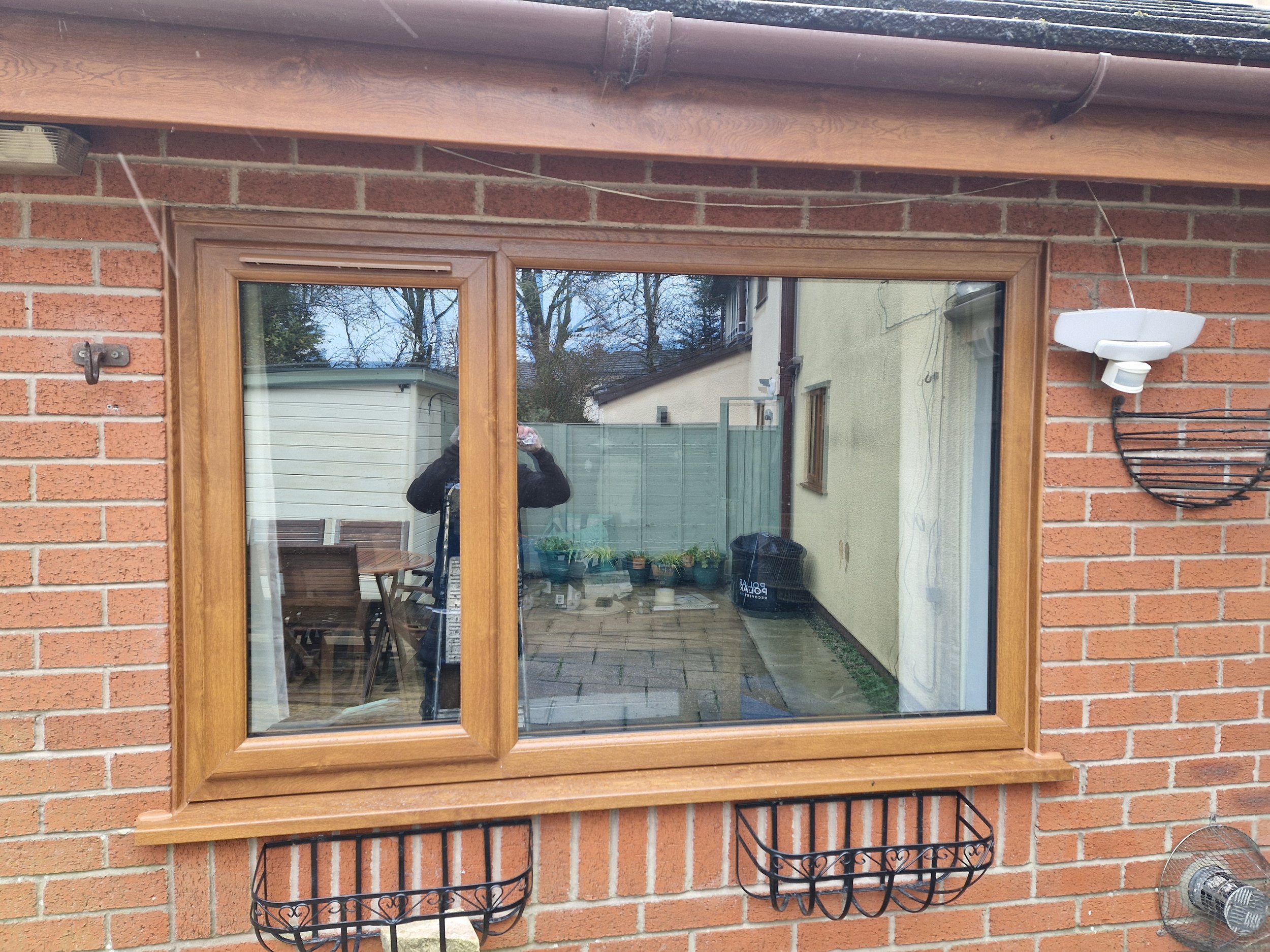 Oak PVC window featuring a practical side-opening casement configuration. The realistic timber-effect finish delivers traditional warmth and character to the property exterior.