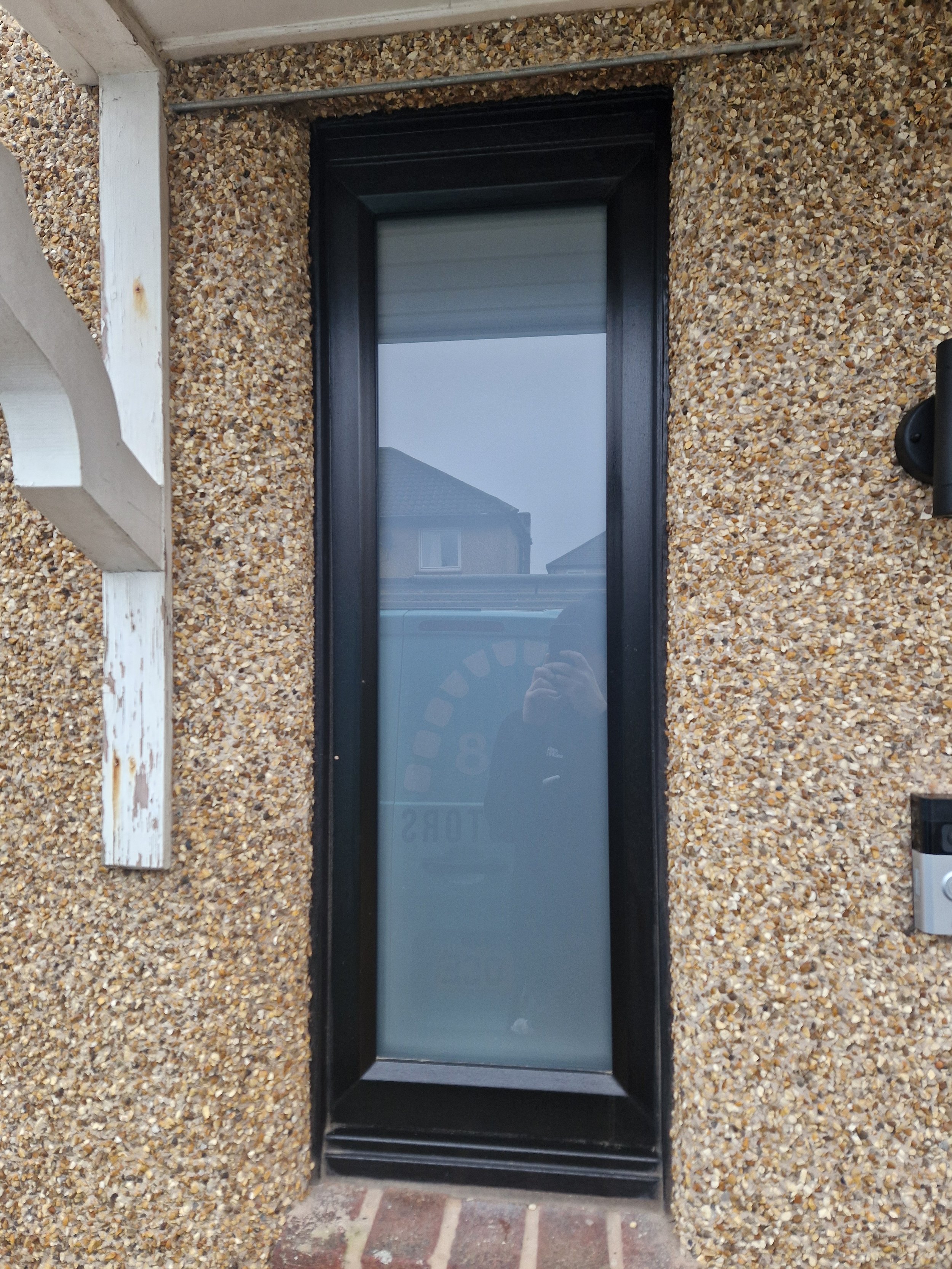 Black PVC window with satin privacy glass.