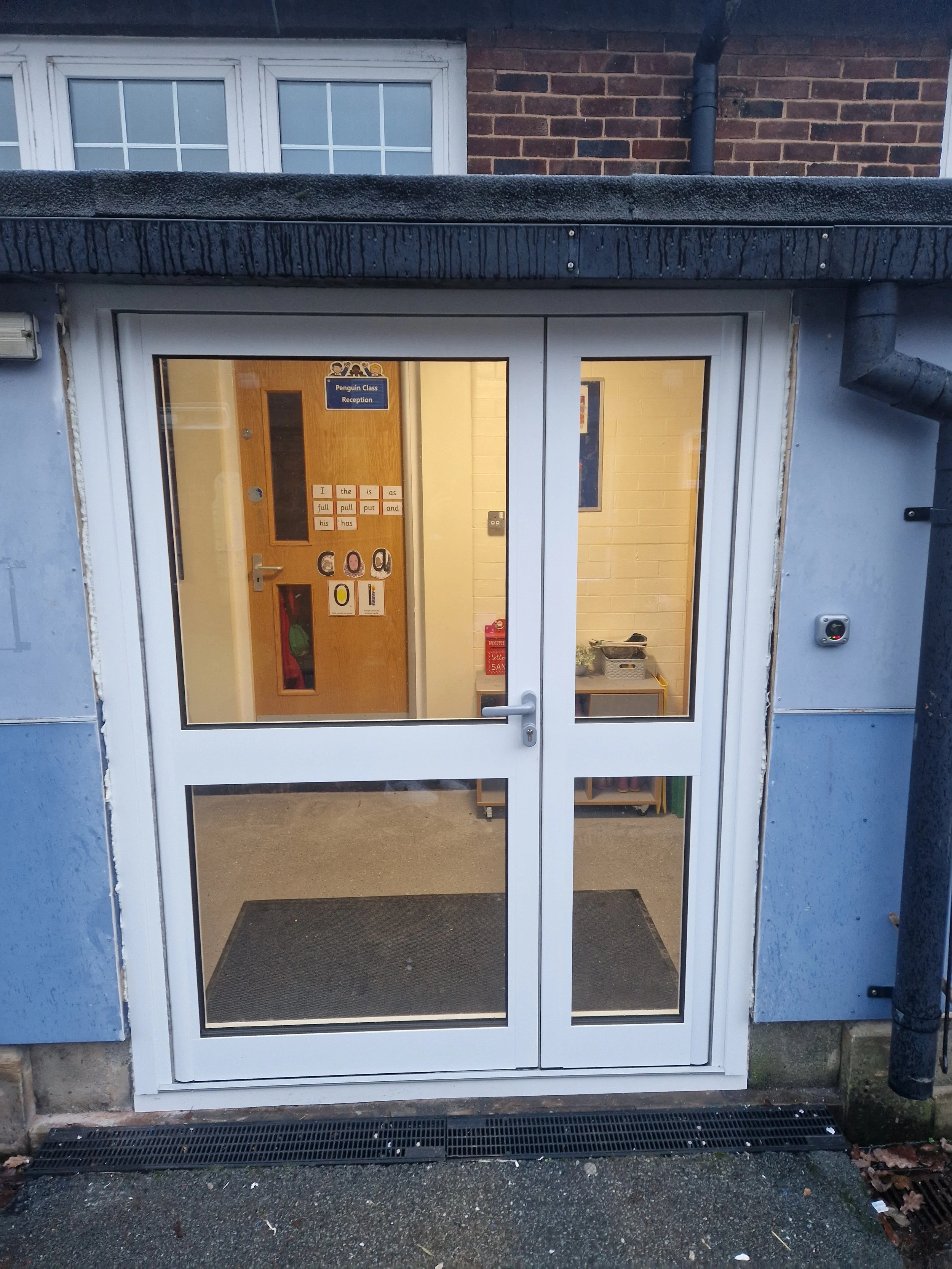 Commercial aluminium door precision-fitted for a school building upgrade. Engineered for high-traffic educational environments, this professional installation features a heavy-duty panic bar mechanism to ensure building compliance and maximum safety.
