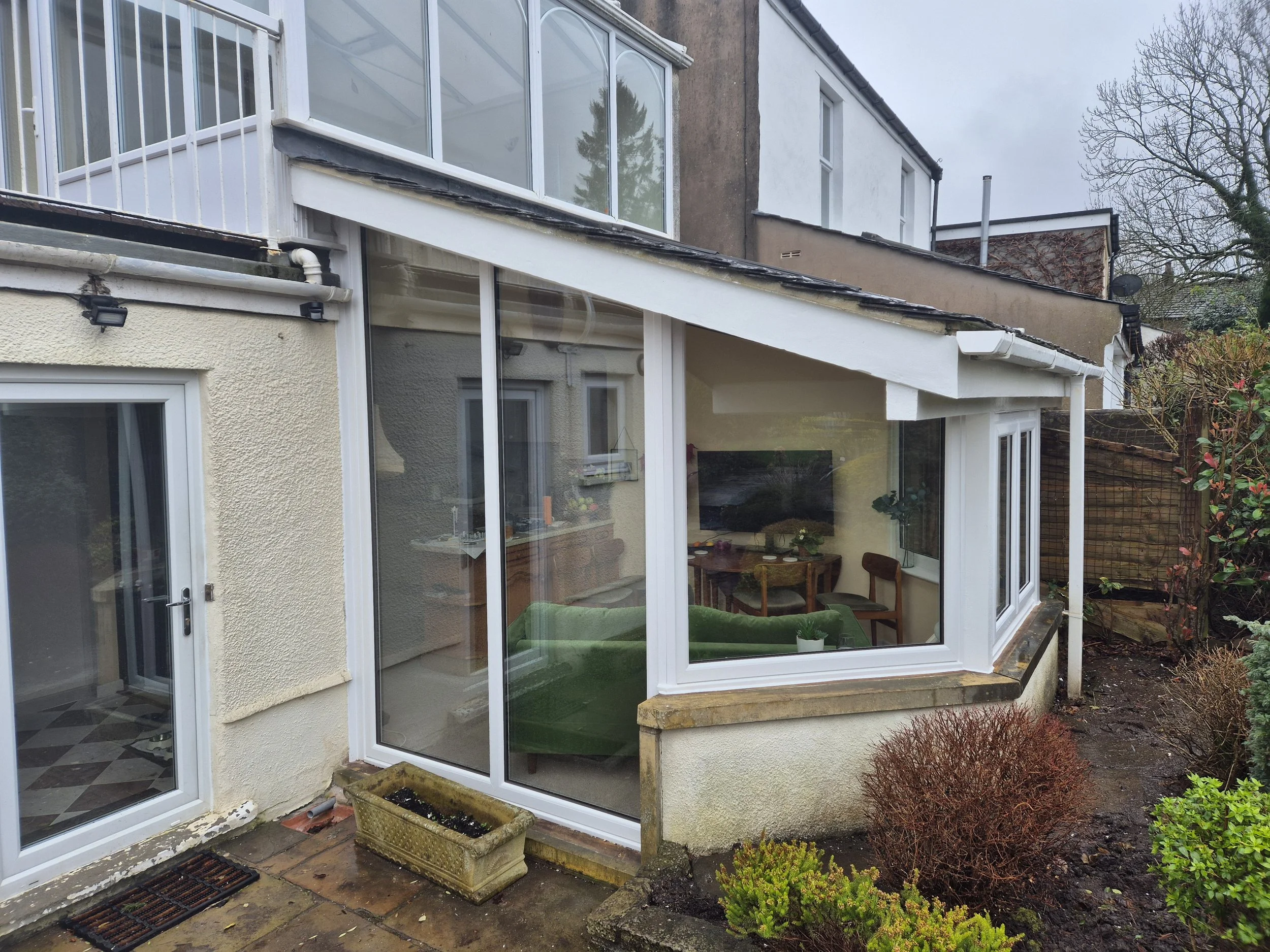 White uPVC conservatory frame upgrade, completely replacing the original rotten wooden frames. This precision-fitted replacement brightens up the room, maximising natural light while restoring thermal efficiency to the back of the property.