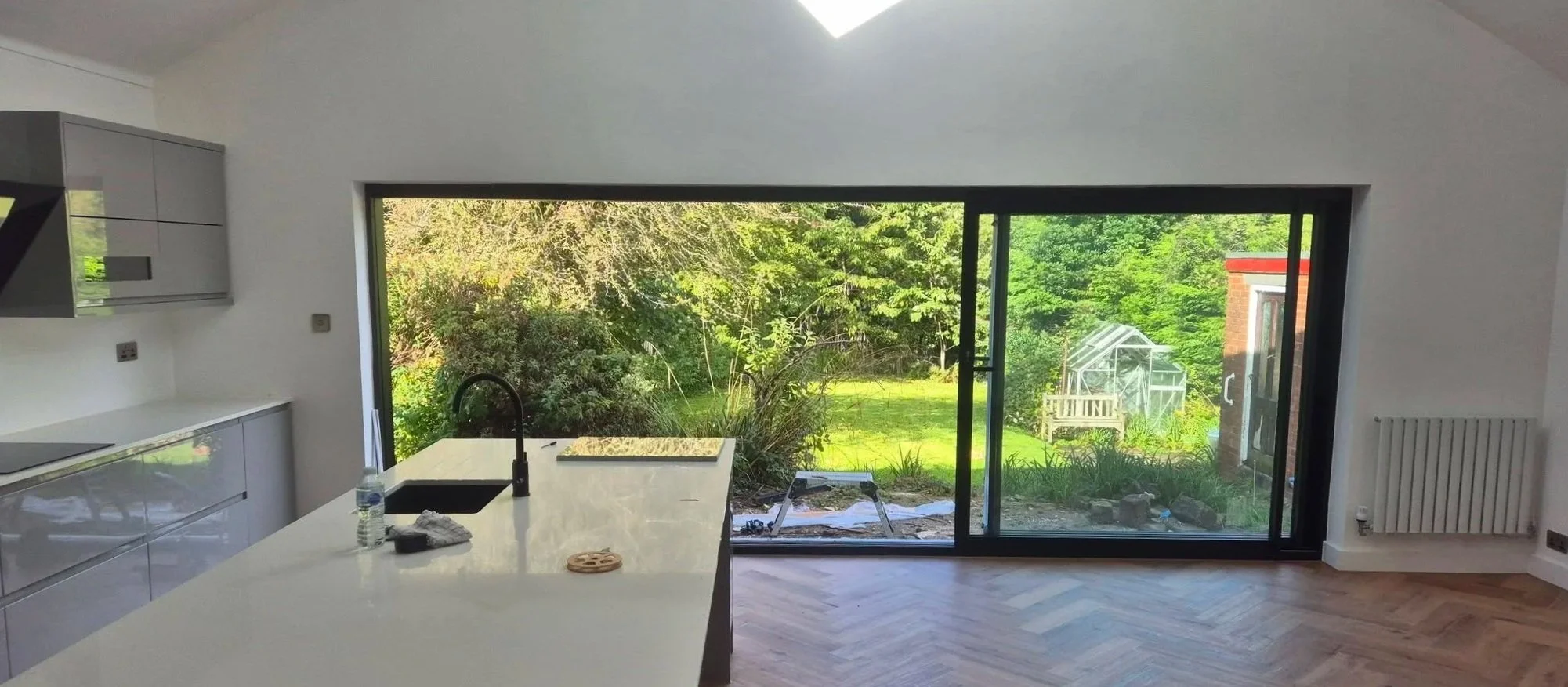 Black aluminium sliding doors installed in a kitchen in Langho