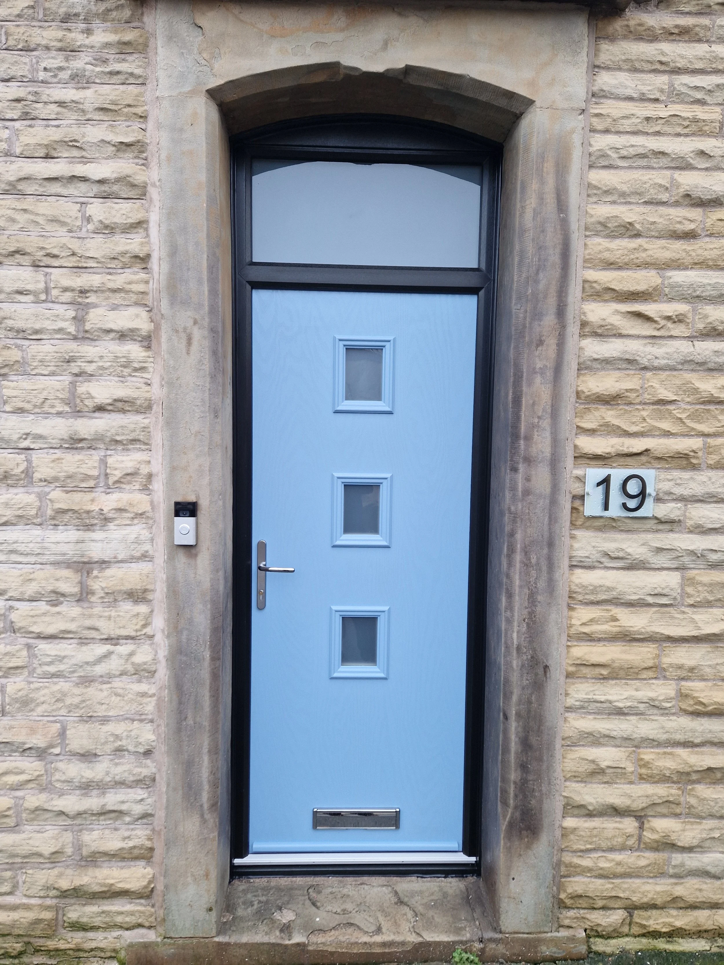 Light blue composite front door featuring three stylish glass privacy panels, expertly fitted within a contrasting bold black frame. This contemporary colour combination delivers a striking, modern aesthetic.