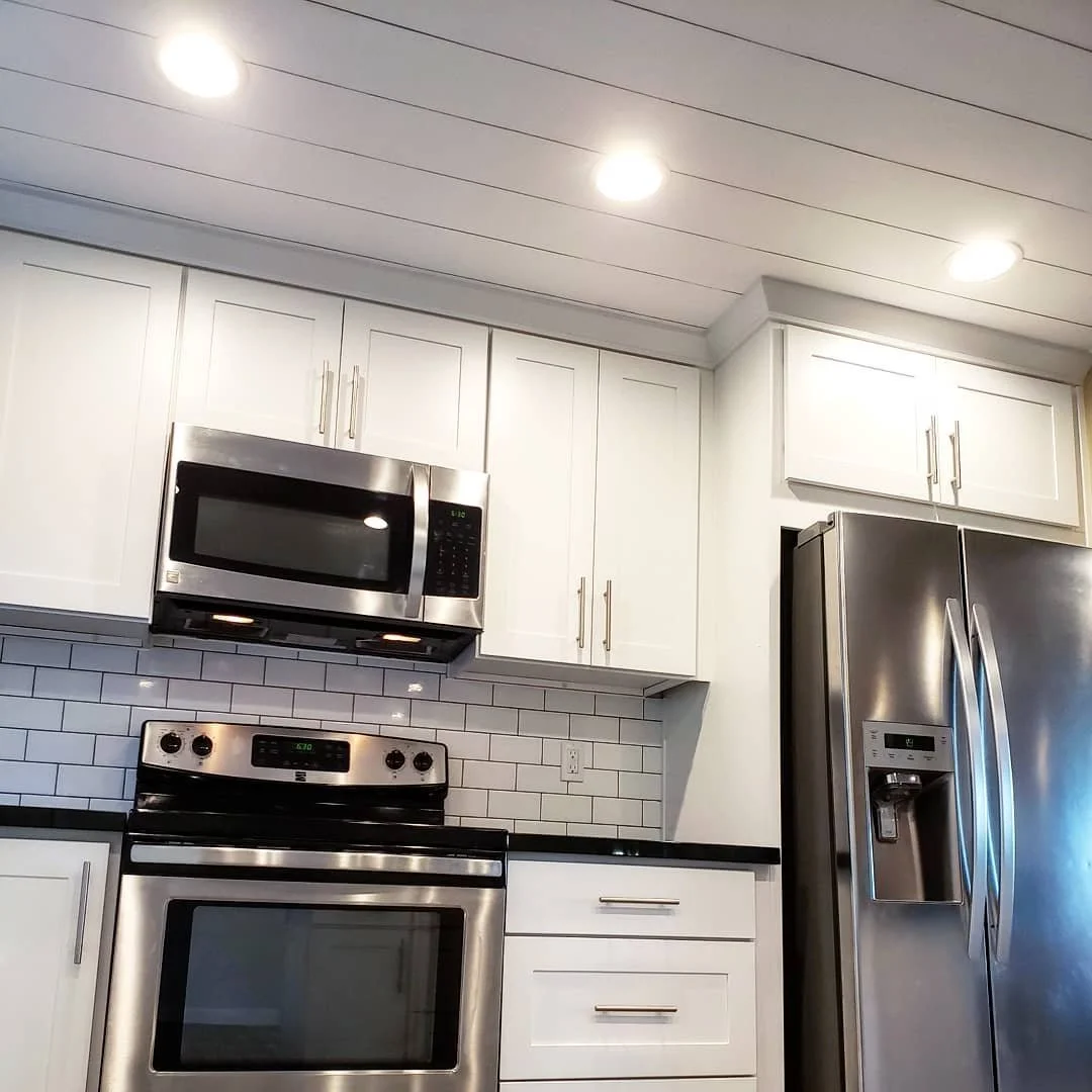 The white and black combo really pops in this Kirkland kitchen remodel. The deep black granite turns into a mirror at the right angle and the white cabinets contrast it well.