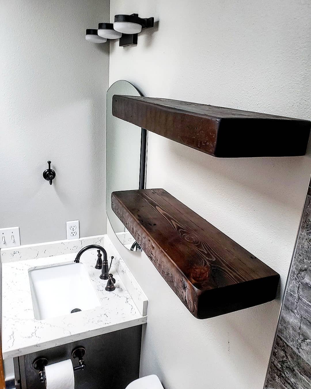 Beautiful Bothell bathroom remodel with reclaimed wood shelving from an East Coast barn and an ultra deep tub with clean edges.