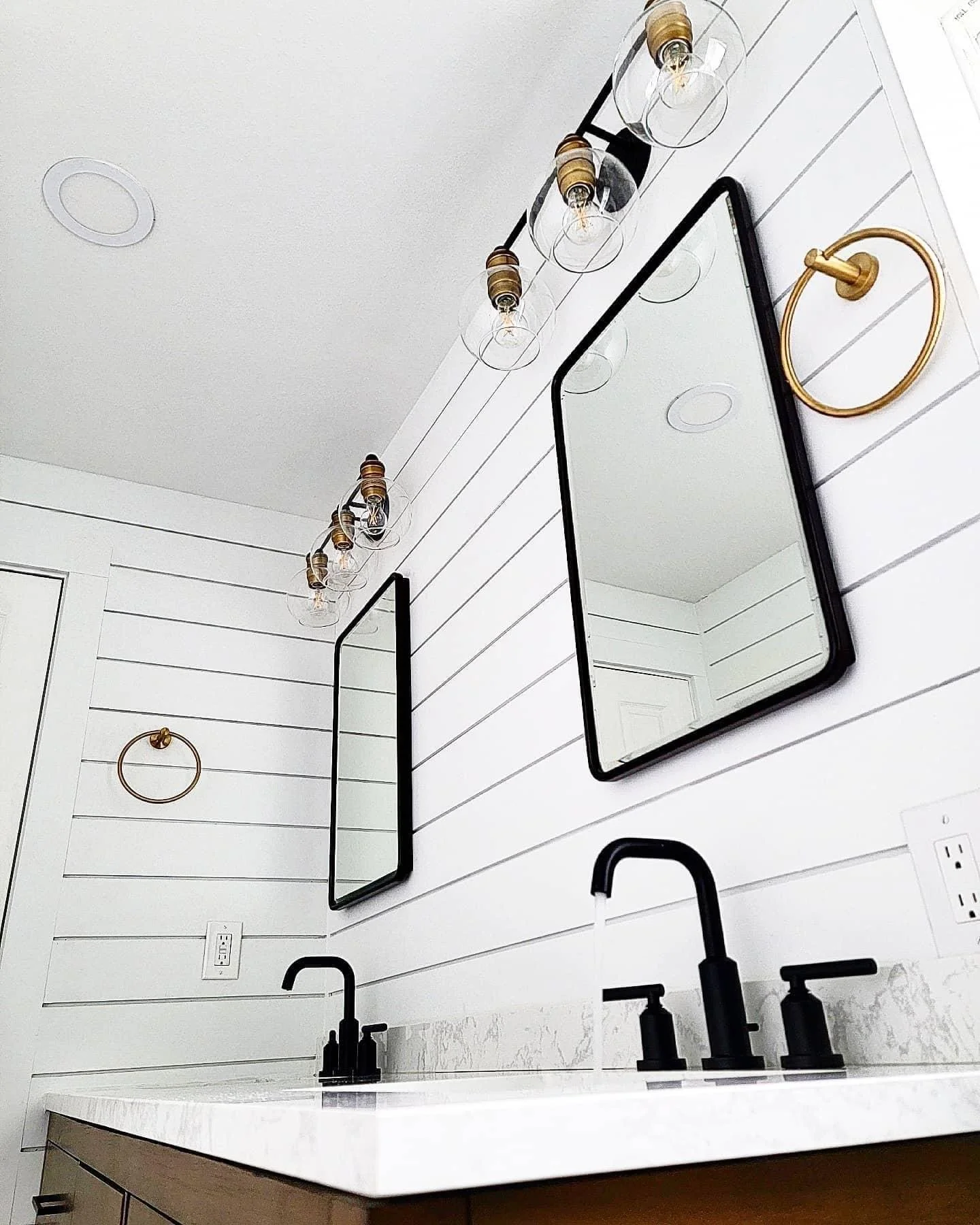 Lynnwood bathroom remodel with black and white finishes to match the flow of their house, the gold brings out their adventurous side, and the nice clean lines leave a lasting impression. We added a sink, turned two windows into one, moved the toilet 