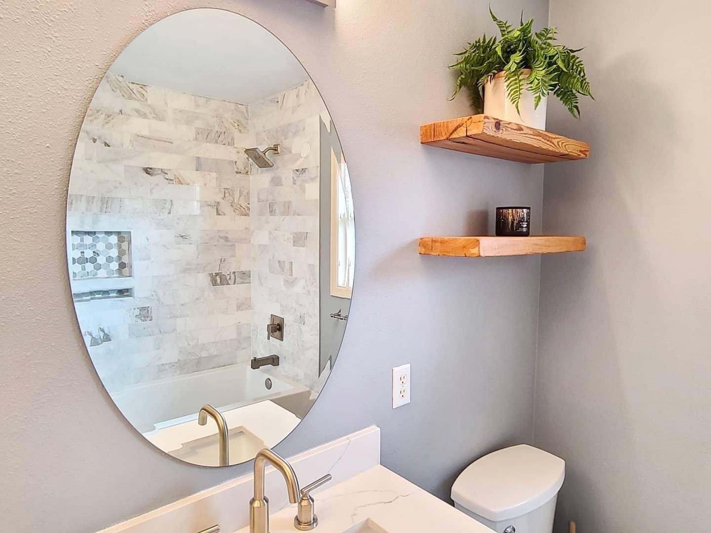 Bright and beautiful Sammamish hall bath remodel with reclaimed wood shelving and elegant finishes. 