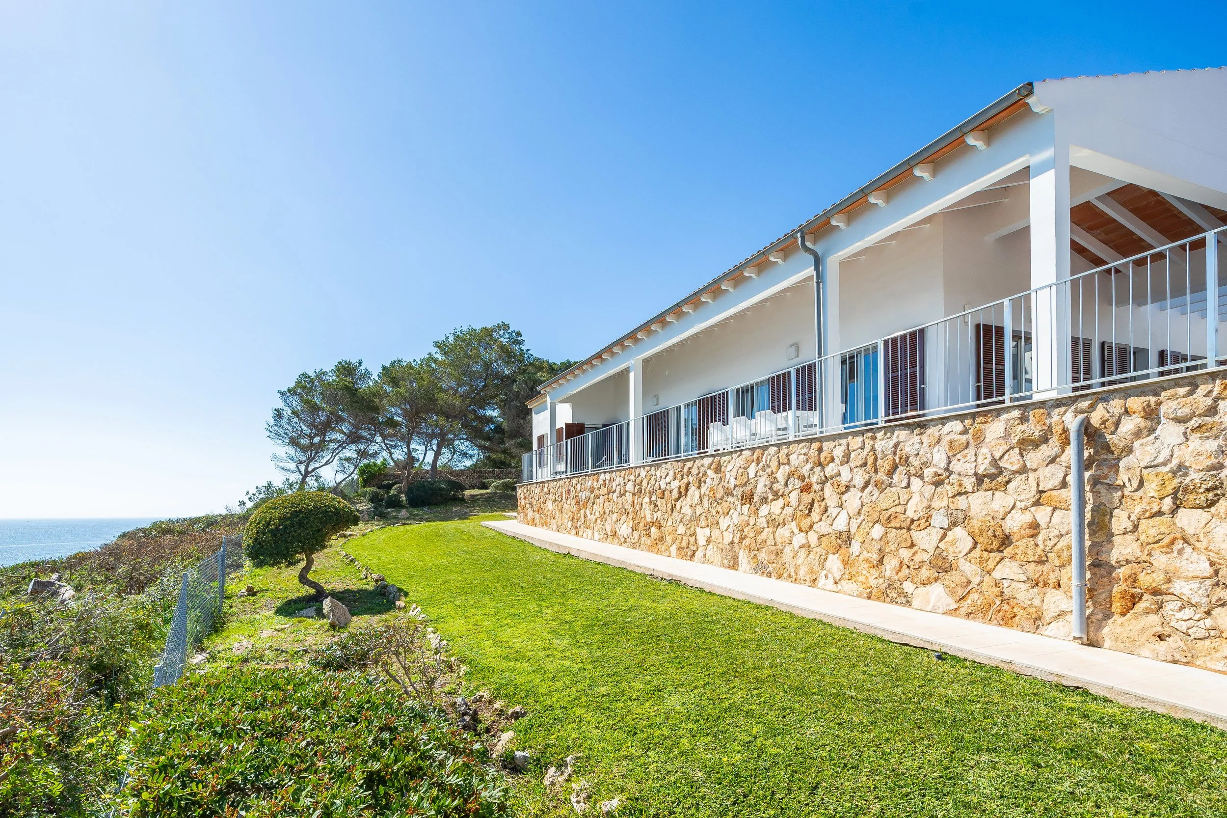 Cinematic real estate photography of Can Fernando Es Pontàs Mallorca with direct views over Es Pontàs natural arch and coastline