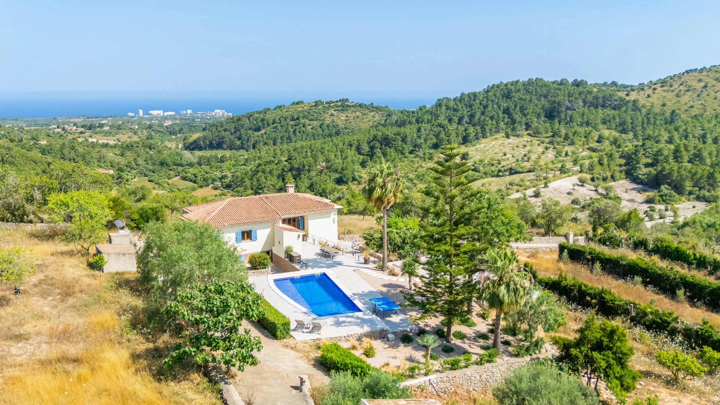 Aerial drone photography of Can Gomez Mallorca countryside house with pool and panoramic views over Calas de Mallorca coastline