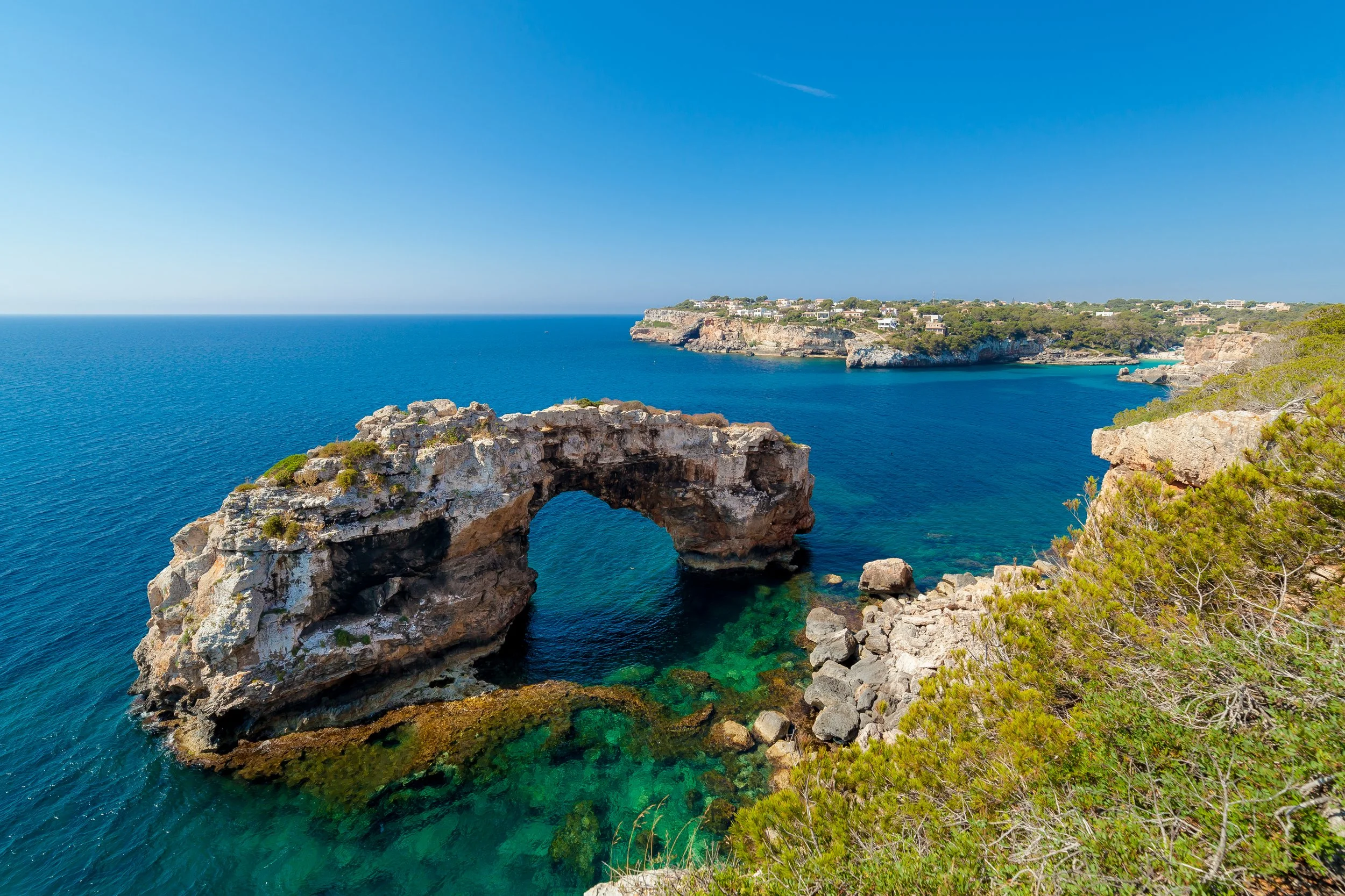 Cinematic real estate photography of Can Fernando Es Pontàs Mallorca with direct views over Es Pontàs natural arch and coastline