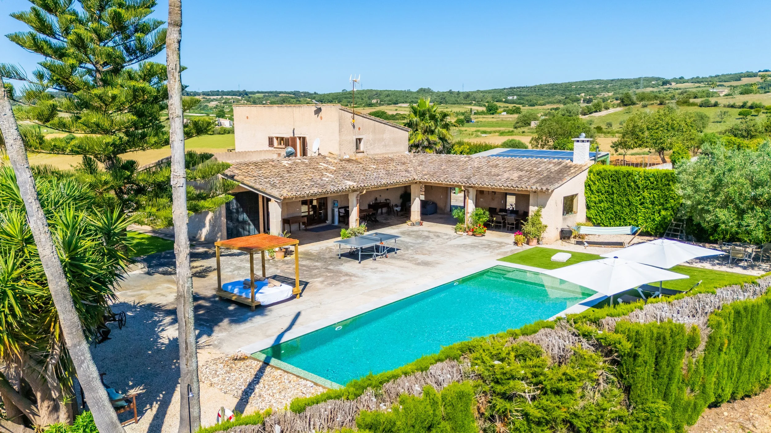 Aerial drone photography of rural house with pool and open field views in Mallorca countryside