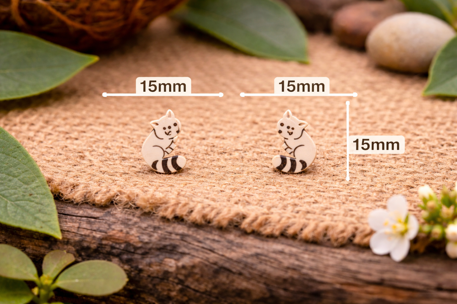 Wooden cat earrings on rustic surface.png