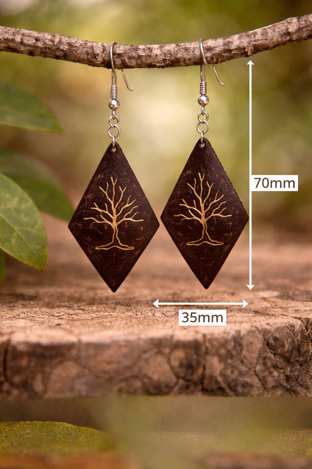 Coconut shell earrings with golden tree design.png
