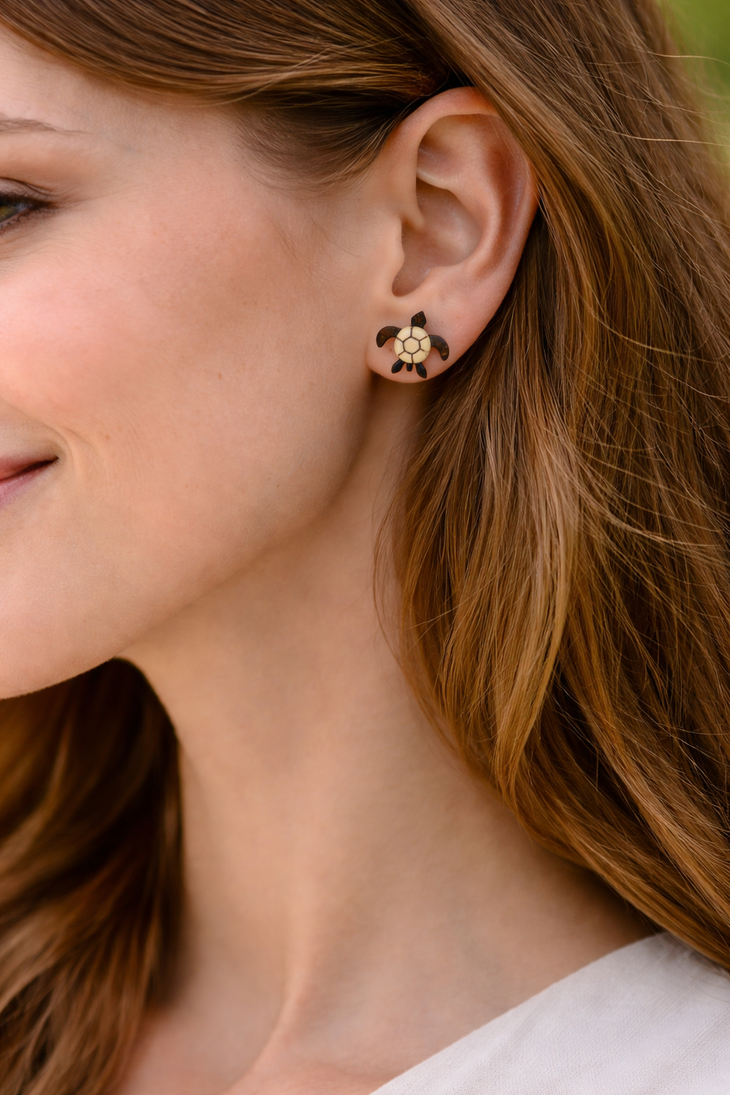 Turtle-shaped coconut shell earrings close-up.png