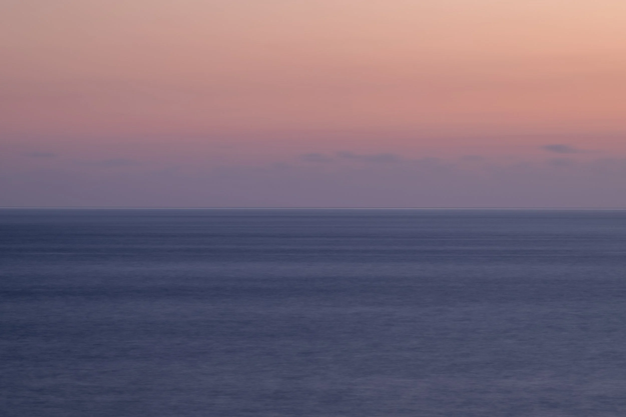 Fine Line Horizonpurplish water orange pinkage skies.