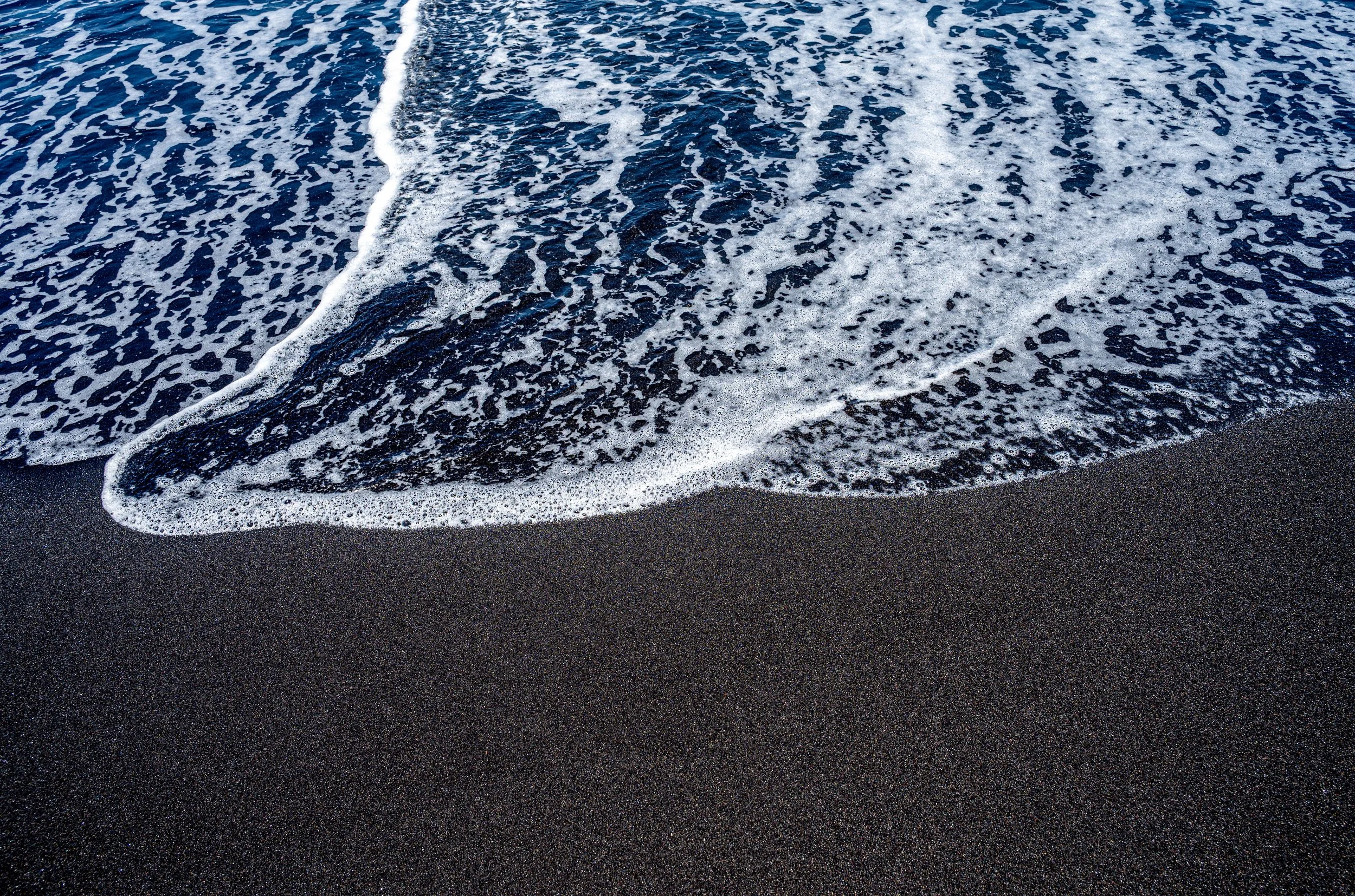 Black beach and white Water