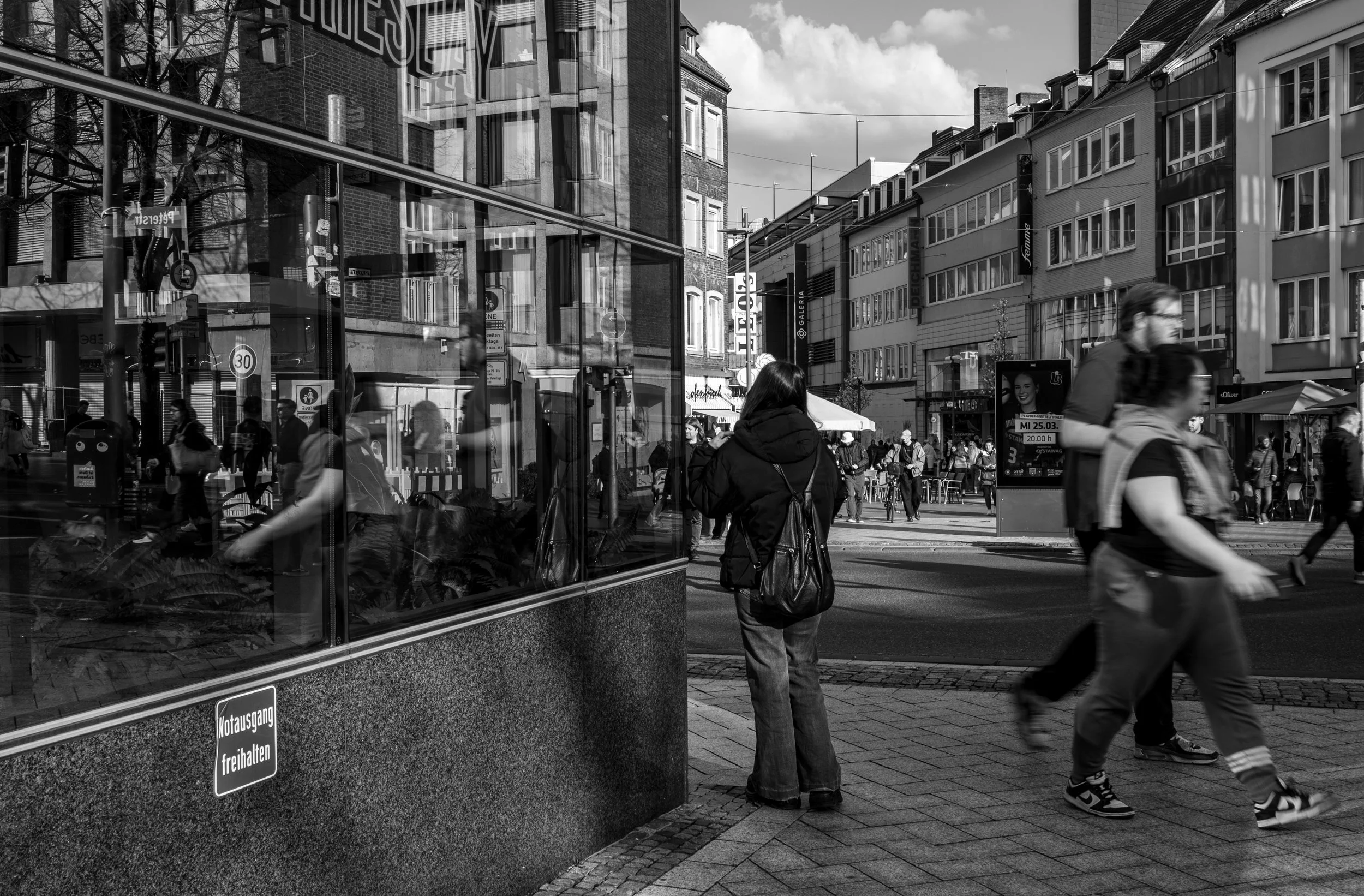 Waiting Girl Reflected in a shopping window in de middle of the city.
