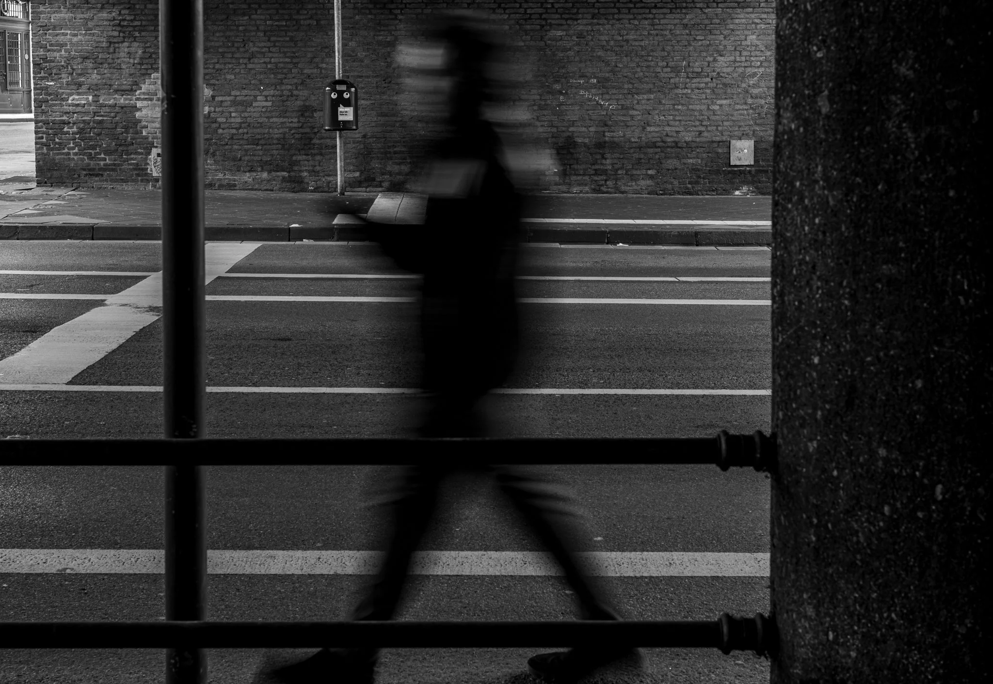 Under a bridge near the Bushoff of Aachen a blured person walks by between different structural lines