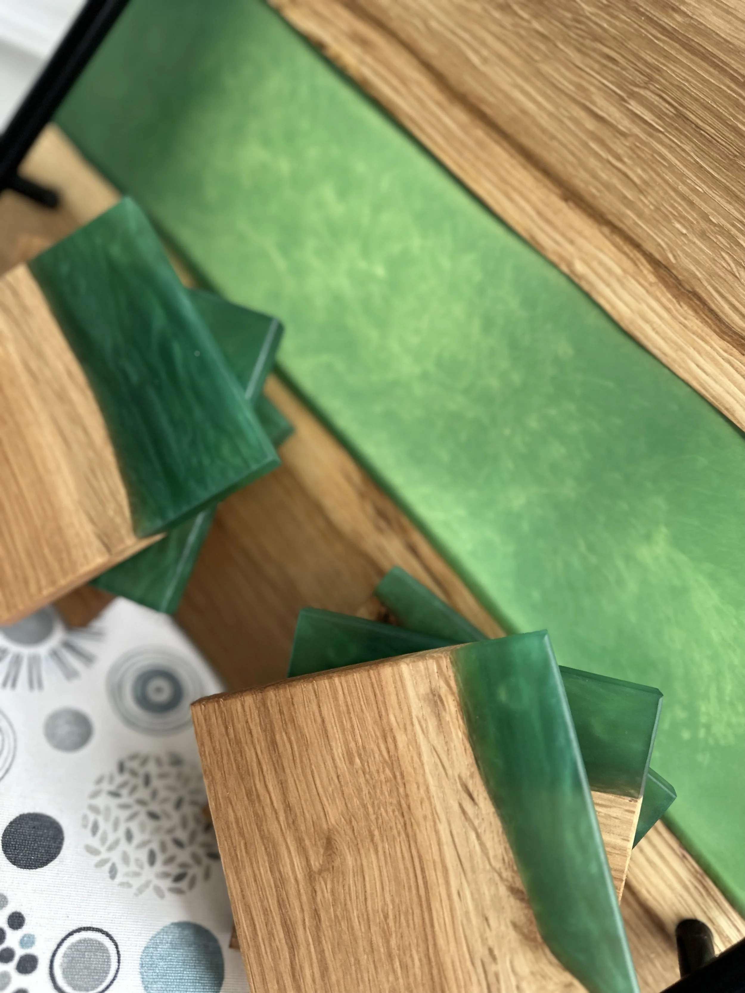Close-up of a wooden structure with green glass or acrylic accents and a green surface with textured pattern.