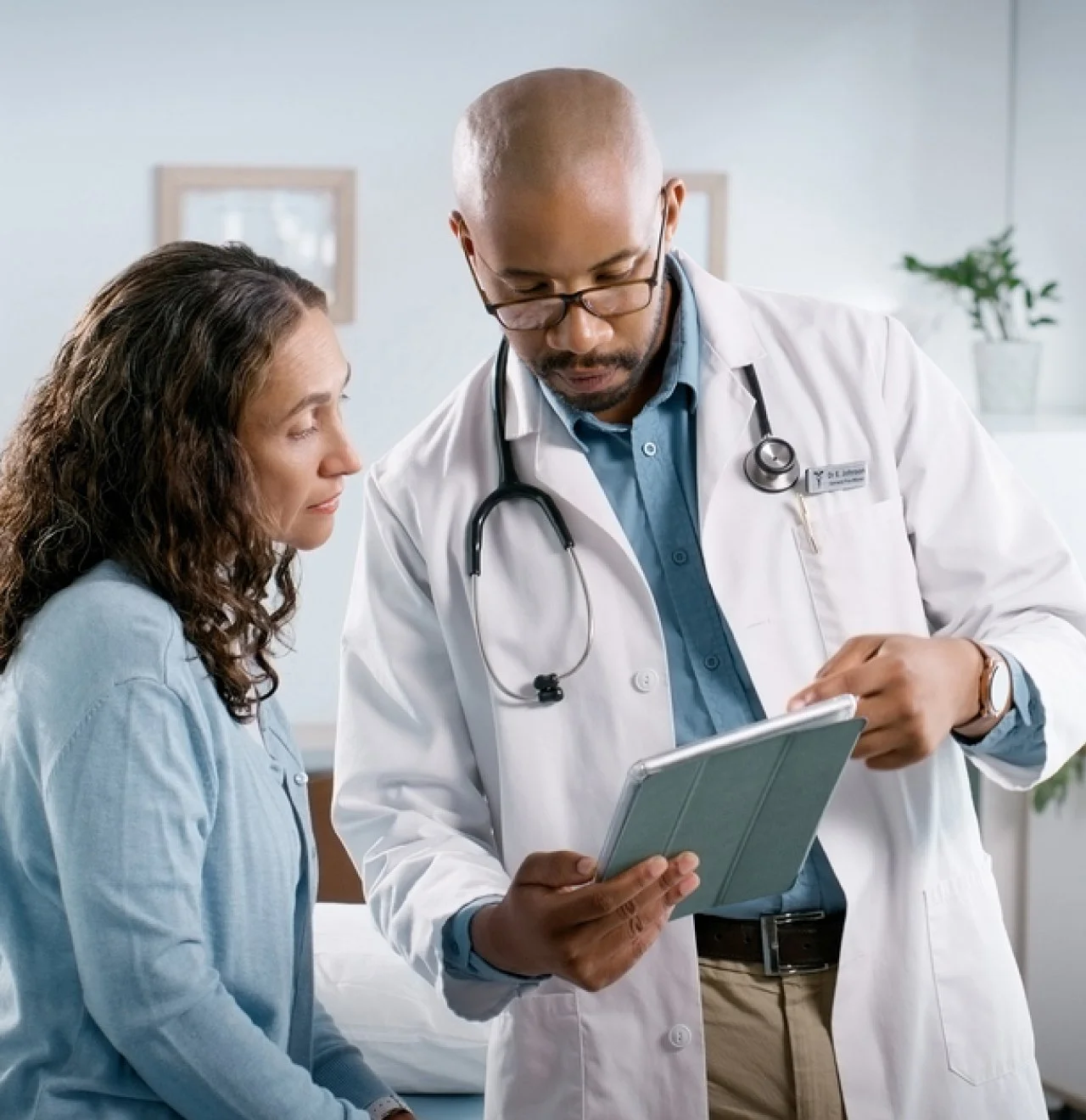 A patient and a doctor, representing the support of a Rural Health Transformation Program (RHTP)