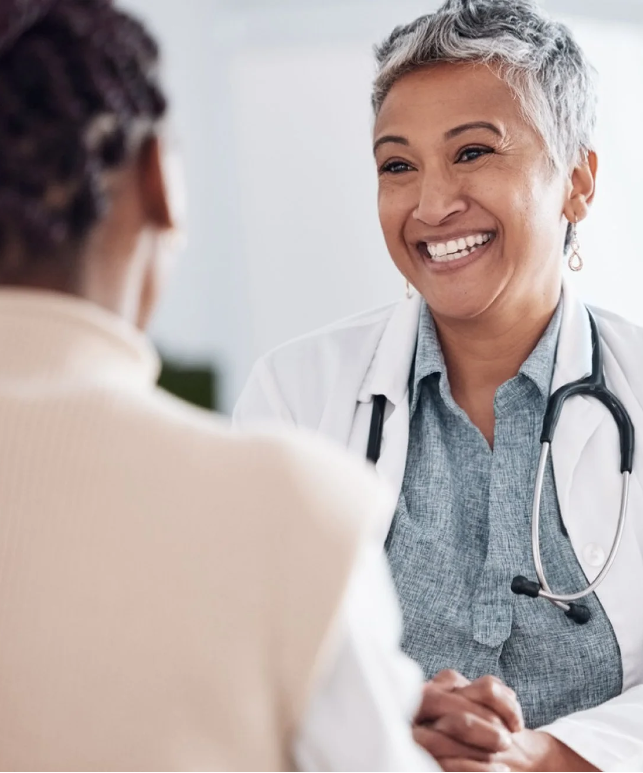 A doctor speaking with a patient, representing healthcare gaps and challenges in access to care in underserved rural areas.