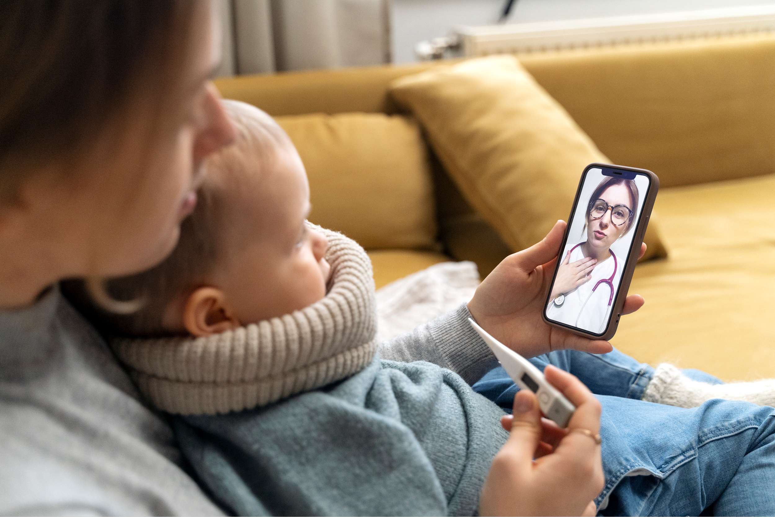 A mother and child speaking with a doctor over the phone, illustrating accessible care and remote support through Healthcare Transformation Consulting.