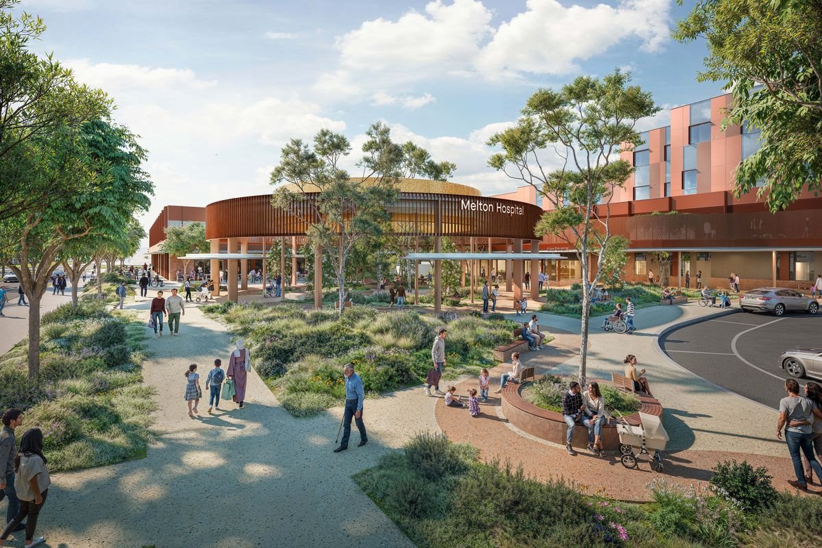 Artist's rendering of Melton Hospital, with people walking, sitting, and children playing in landscaped outdoor space featuring trees and bushes.