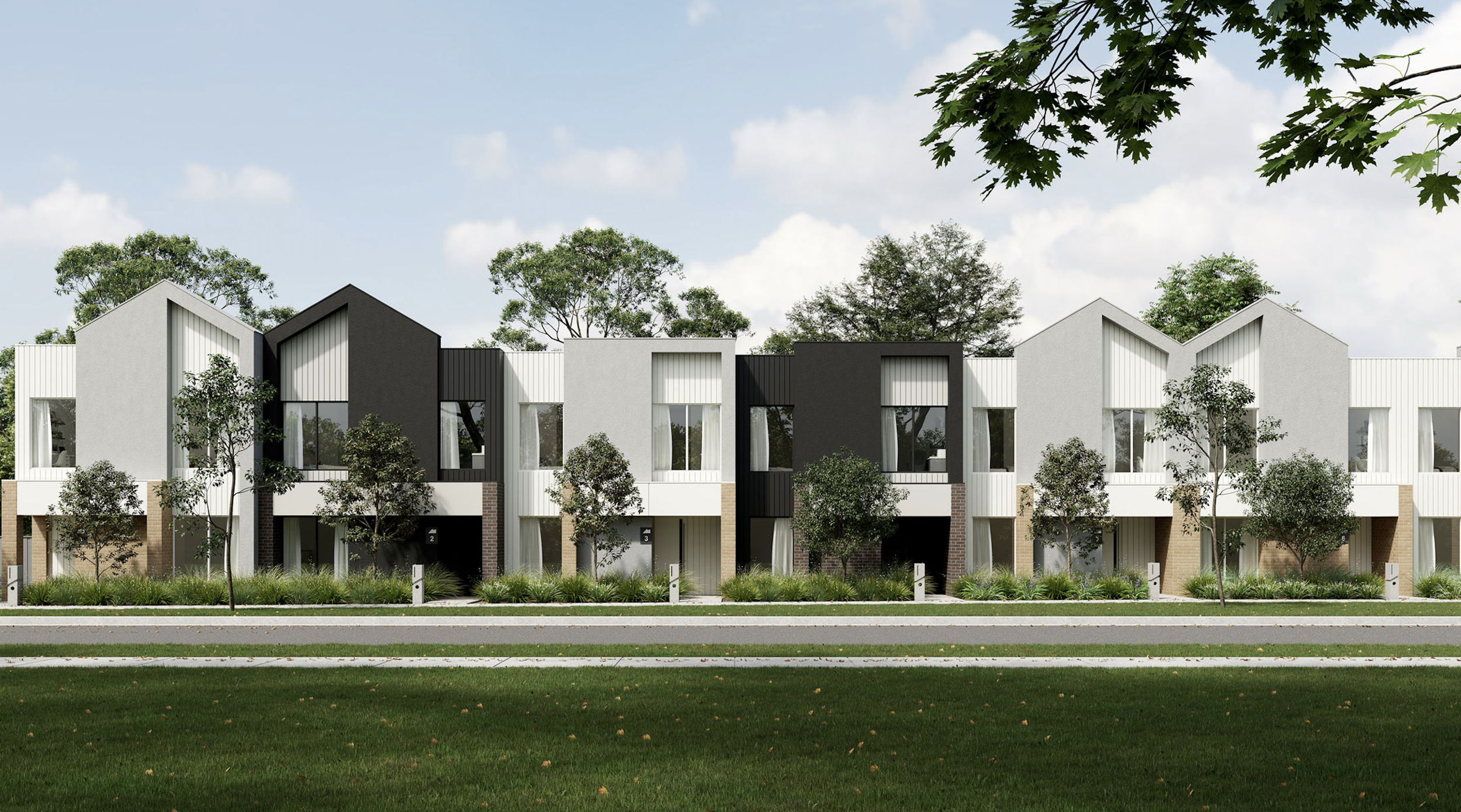 Modern residential townhouses with white and black facades, large windows, landscaped front yards, and trees under a partly cloudy sky.