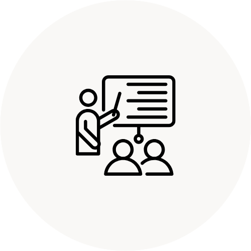 An icon of a person giving a presentation or lecture to two seated individuals in front of a screen with text