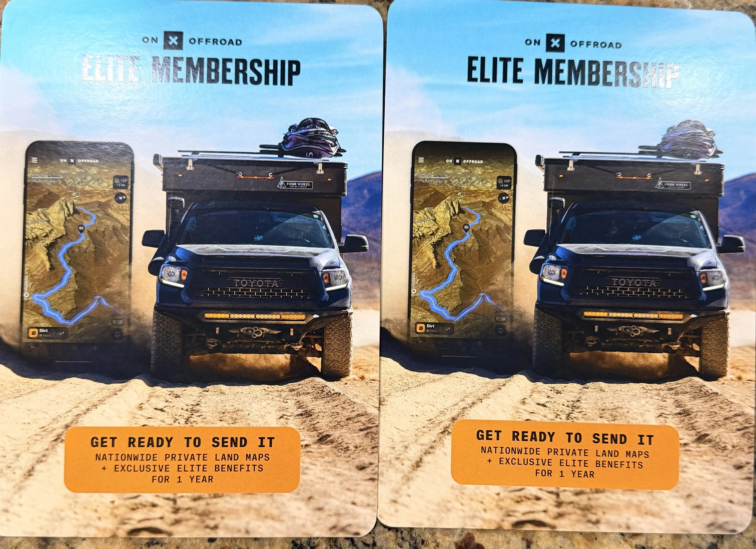 Two similar promotional flyers for ONX Offroad Elite Membership, featuring a black Toyota vehicle fitted for off-road use, with a smartphone displaying a desert landscape map in the background, and a yellow-orange banner at the bottom offering private land maps and exclusive benefits for one year.