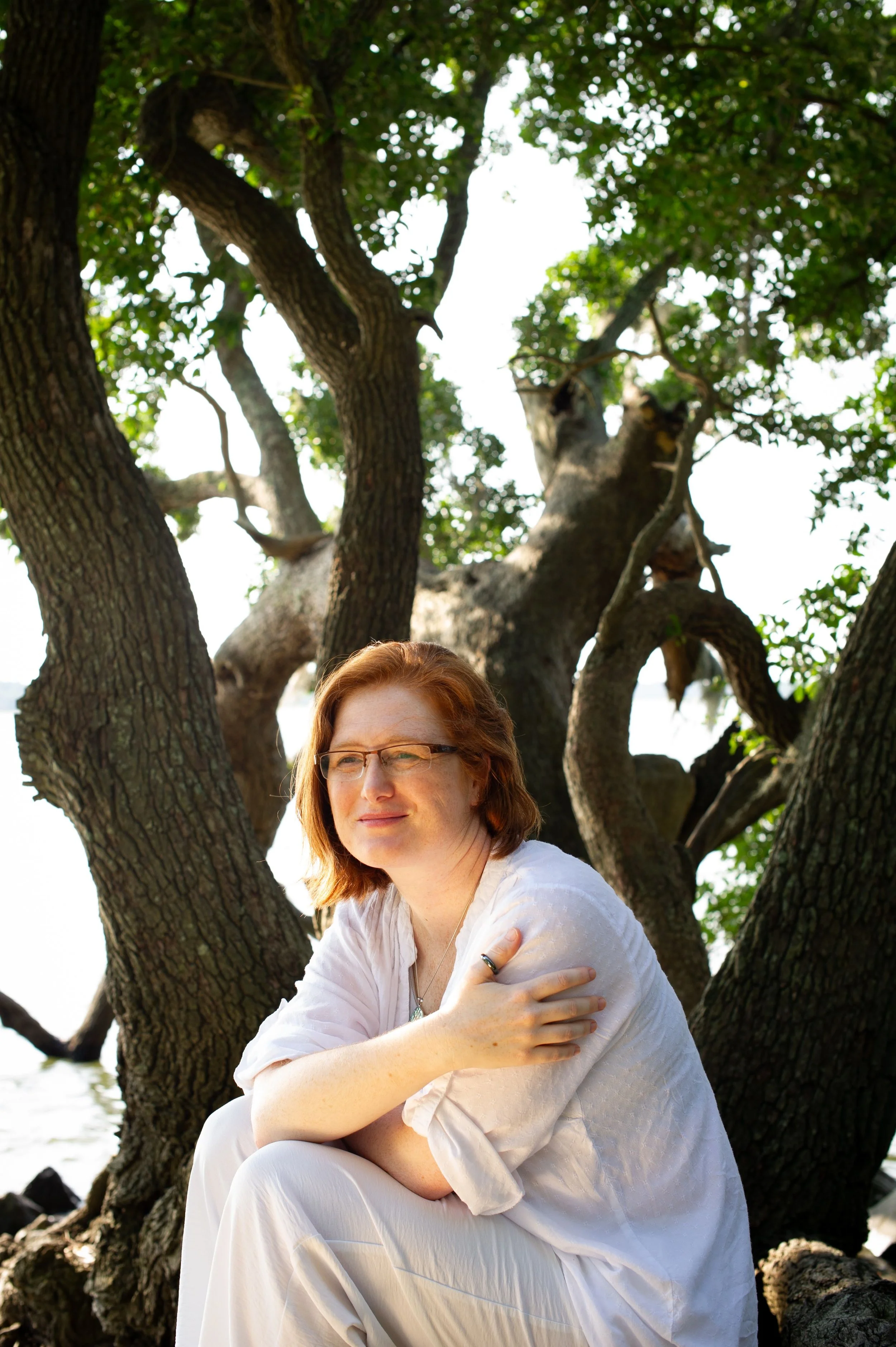 Dena Ewing sitting outside under a tree