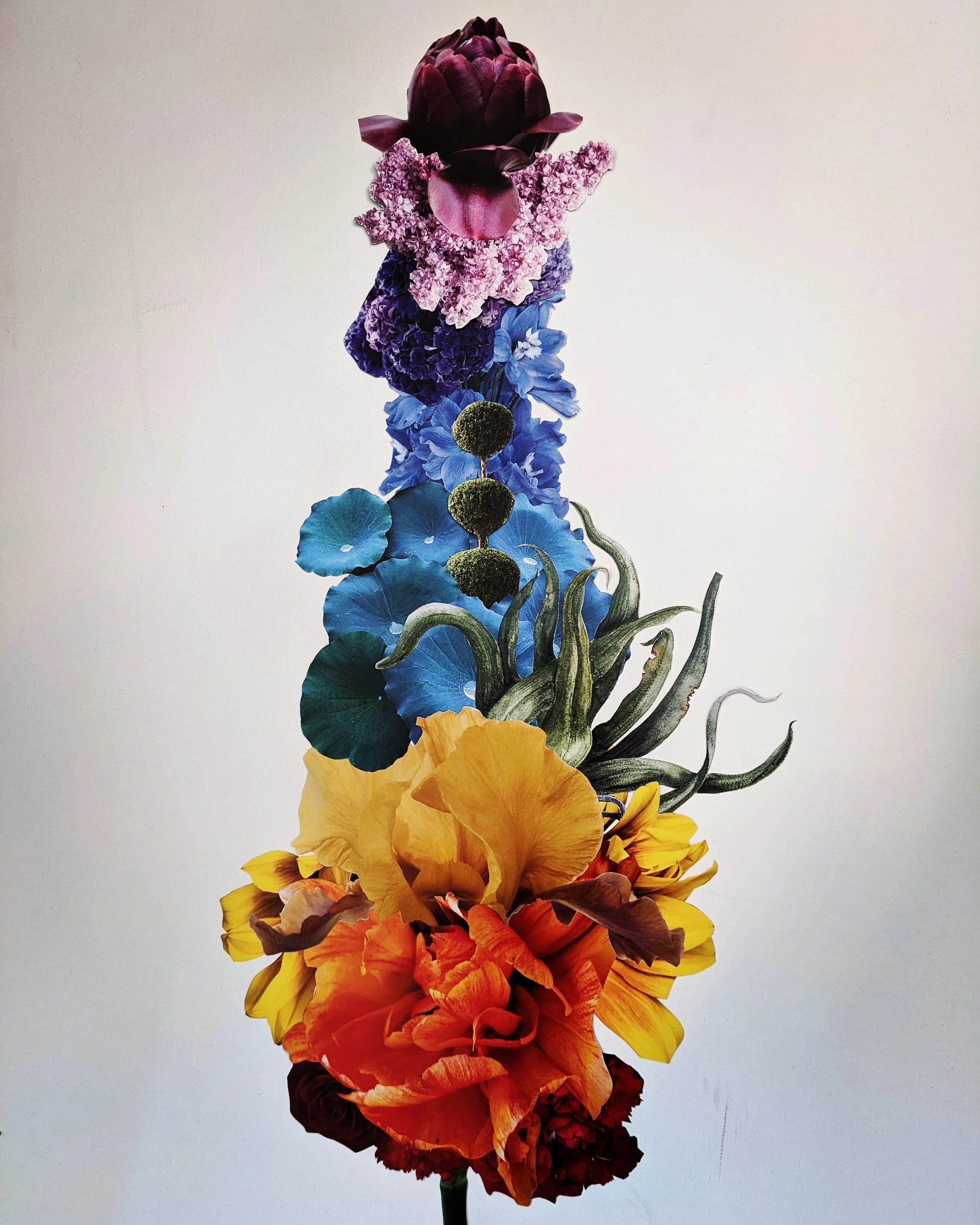 Colorful floral arrangement with purple, pink, blue, yellow, orange, and red flowers