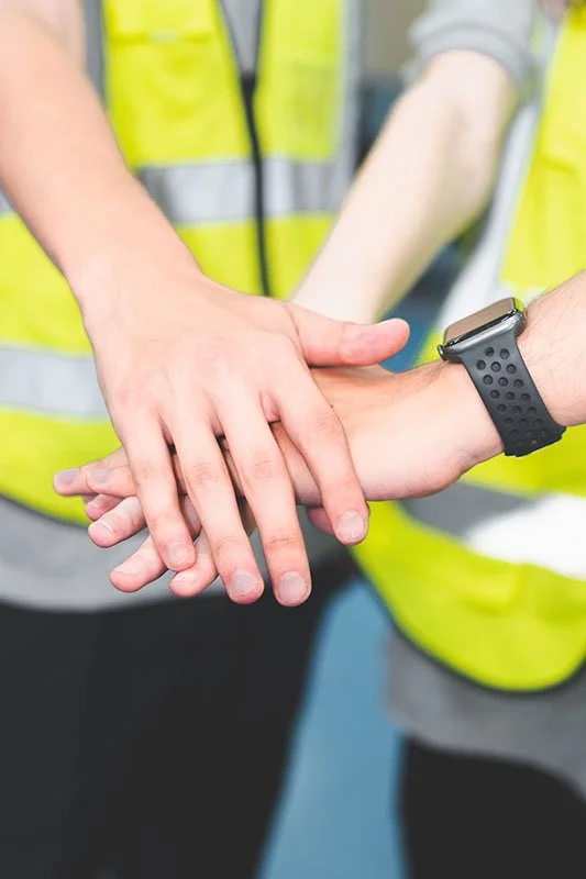 Stacking hands representing teamwork