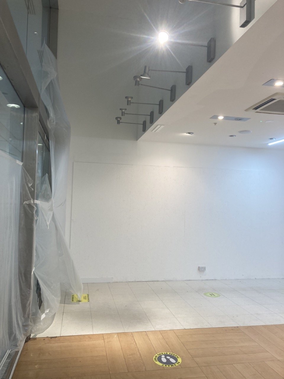 Commercial retail unit decorating project with freshly painted walls and ceiling areas.