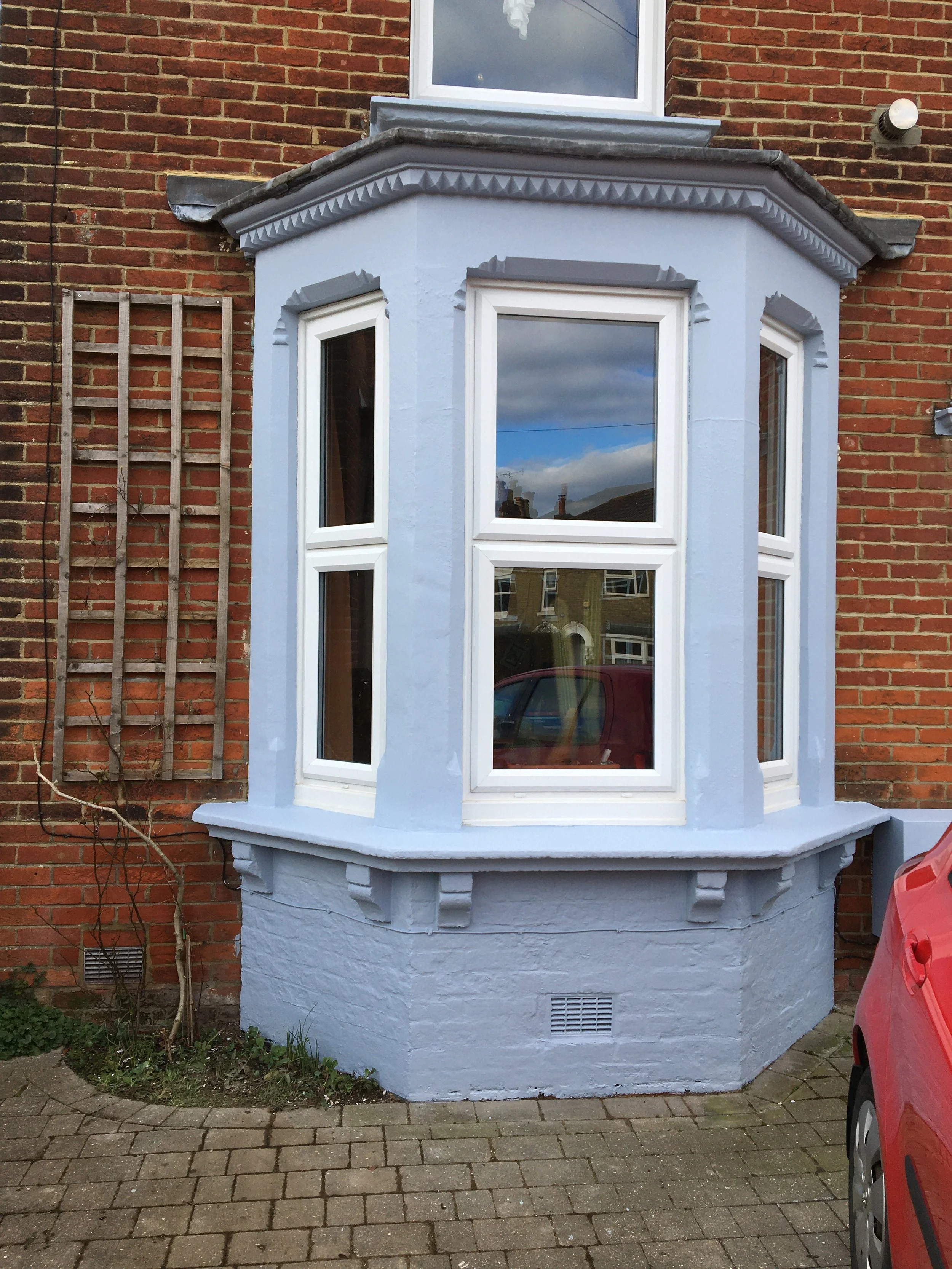 Residential exterior after painting and restoration work with a revived finish.