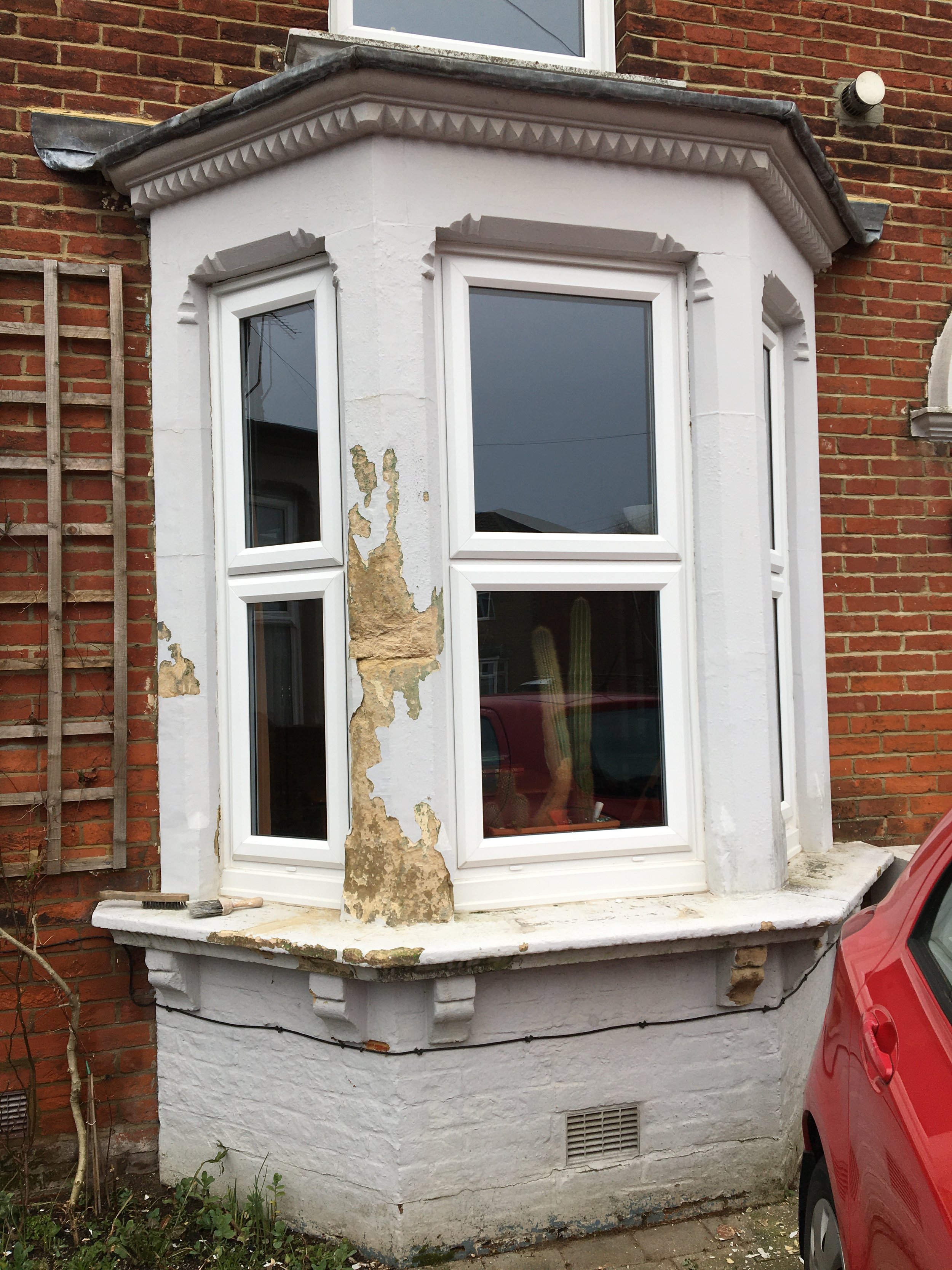 Residential exterior before detailed restoration, painting and decorating work.