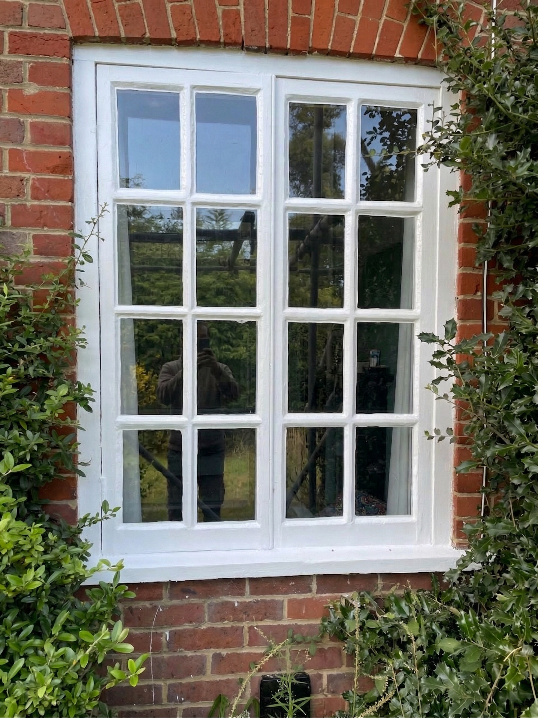 Restored large timber windows with fresh painted finish.