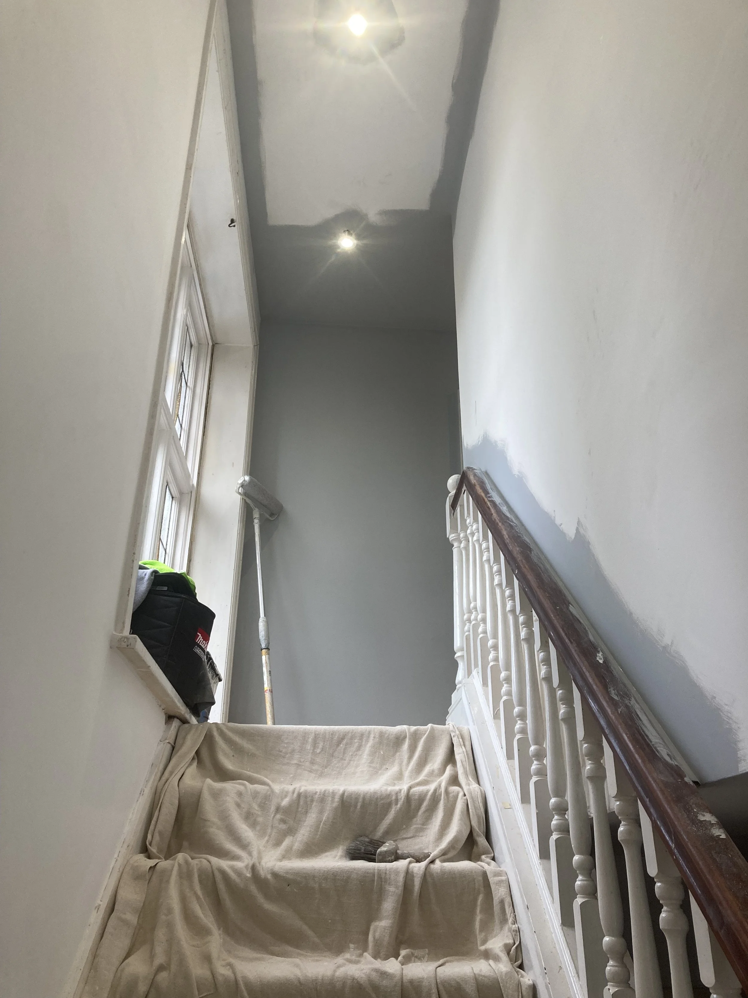 Interior stairway before decorating, during surface preparation.