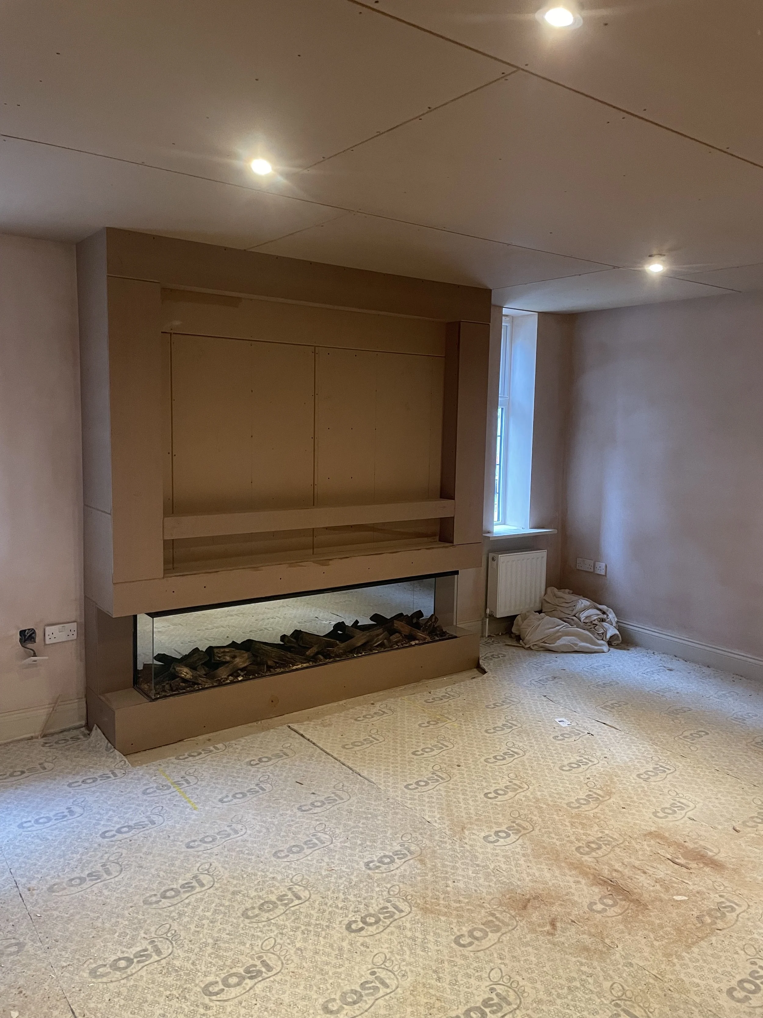 Residential interior console unit and fireplace before full room redecoration.