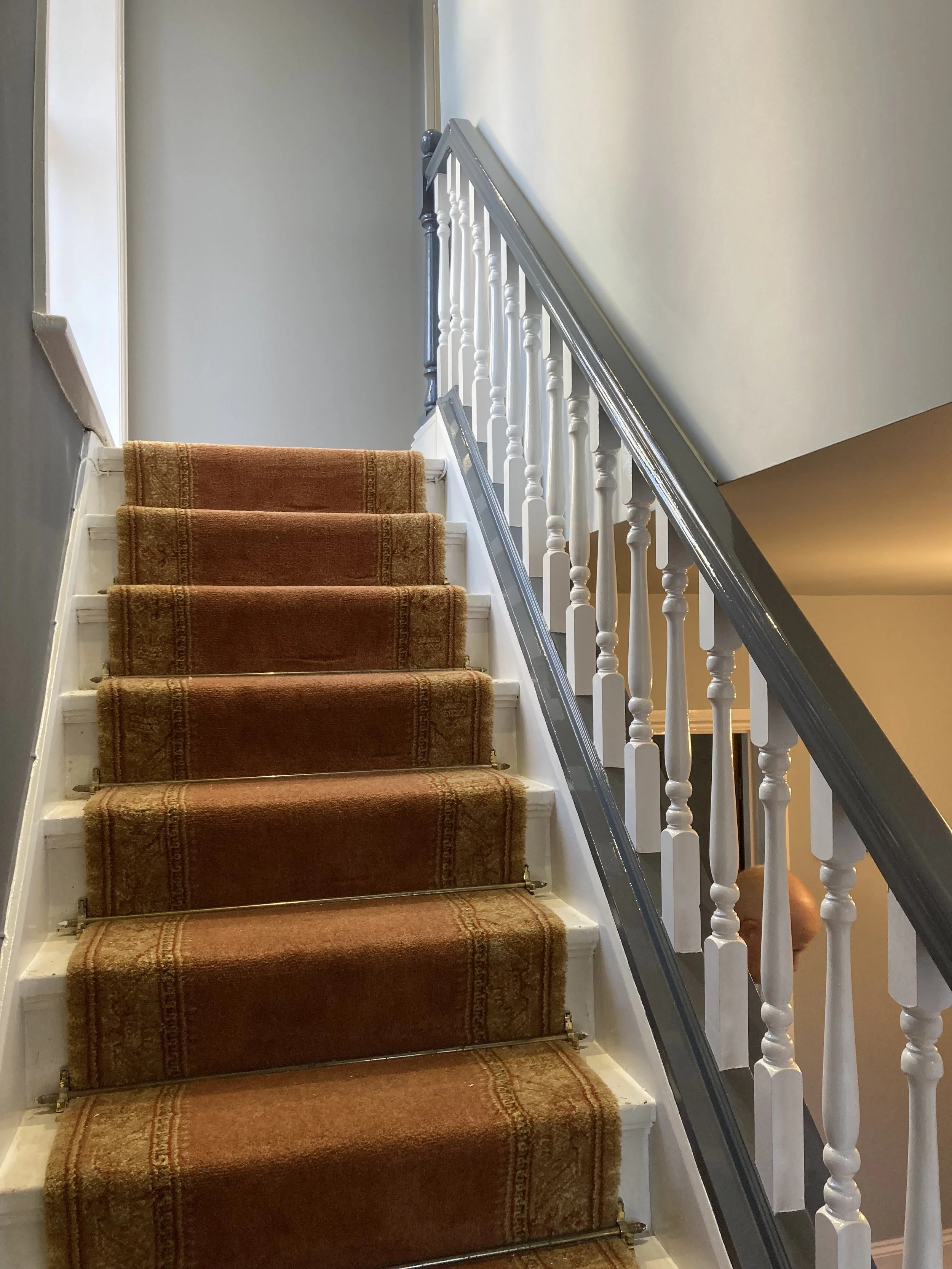 Interior stairway after decoration with a bright, clean painted finish.