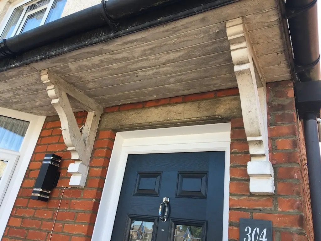Front door before exterior restoration and repainting.