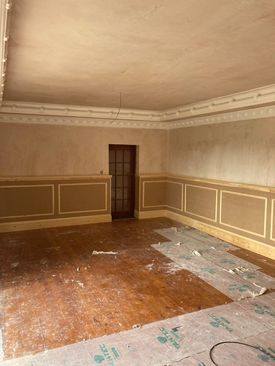 Interior living space before painting, fireplace restoration and finishing.