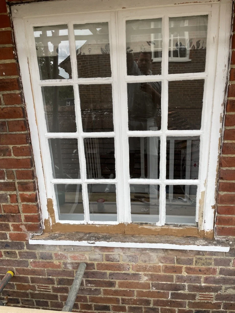 Large damaged timber window before restoration and repainting.