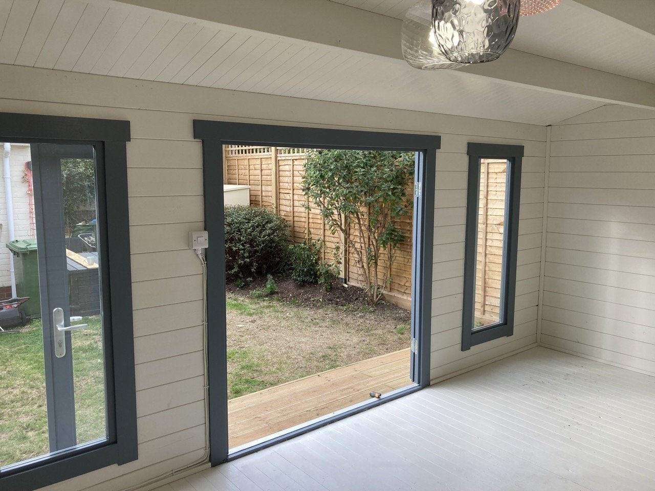 Garden outhouse interior, decorated with bright white walls to a clean professional finish.