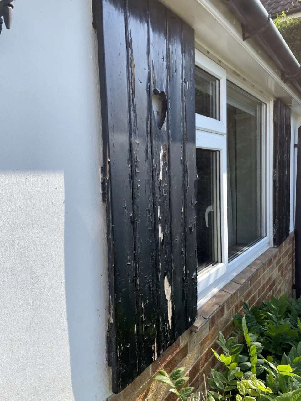 Country house shutters before wood preparation and painting.
