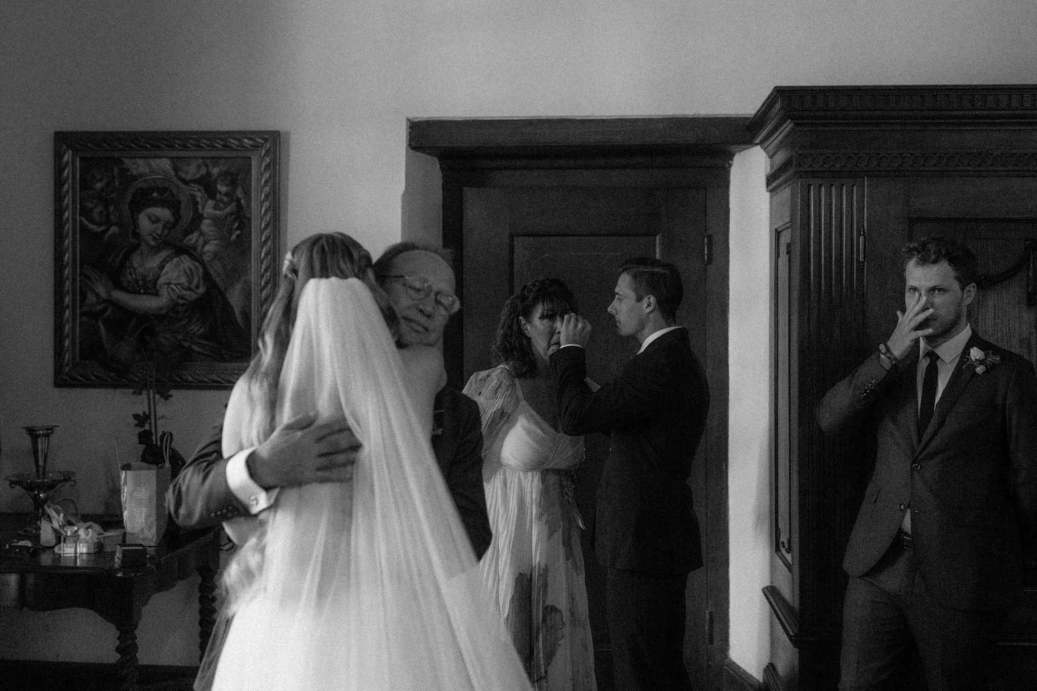 Bride exchanging emotional moment with her parents, brother and best friend moments before their outdoor ceremony at Nooitgedacht Estate in Stellenbosch
