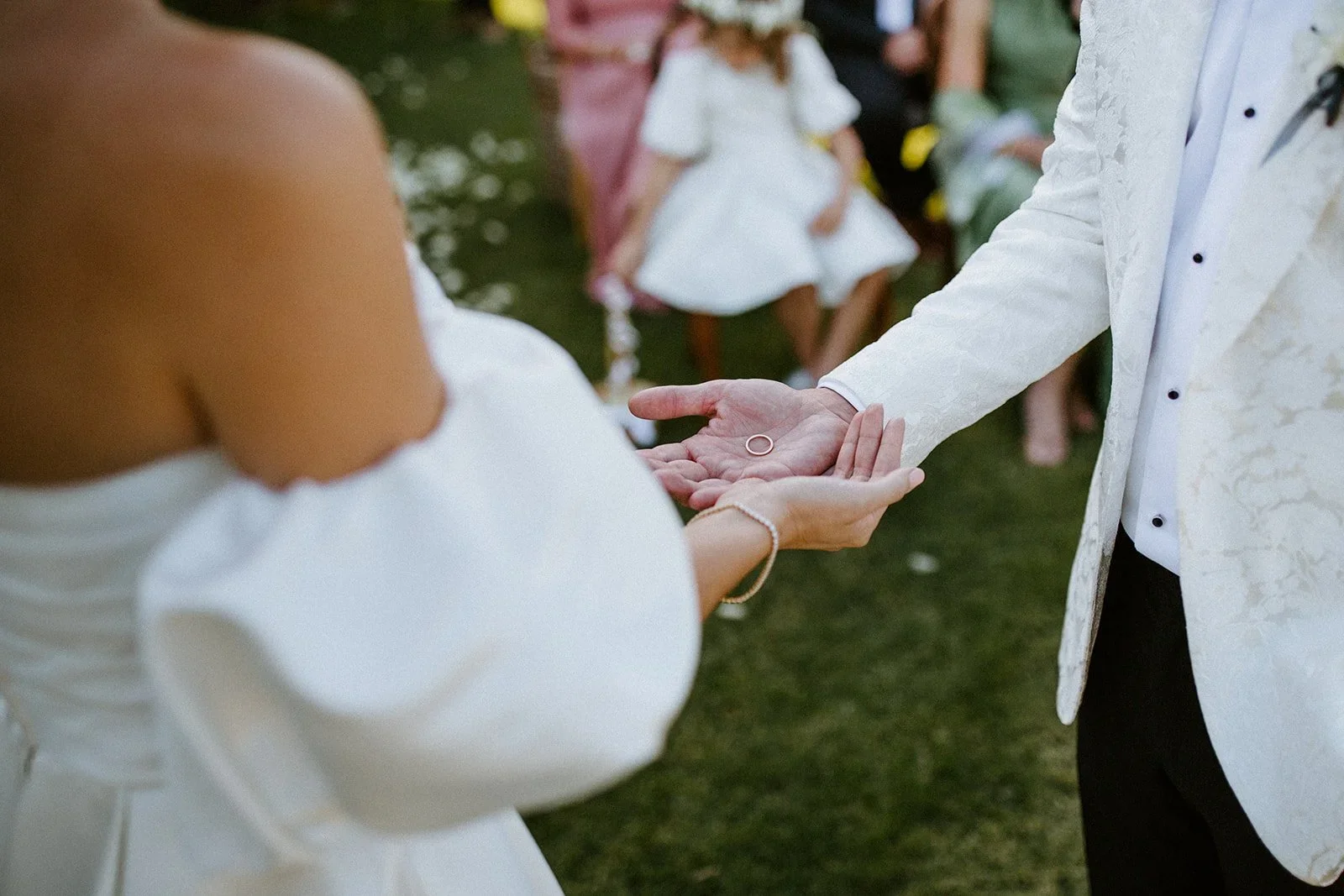Close-up of the bride and groom holding their wedding rings in their open hands before exchanging vows at Johannesdal 1207.